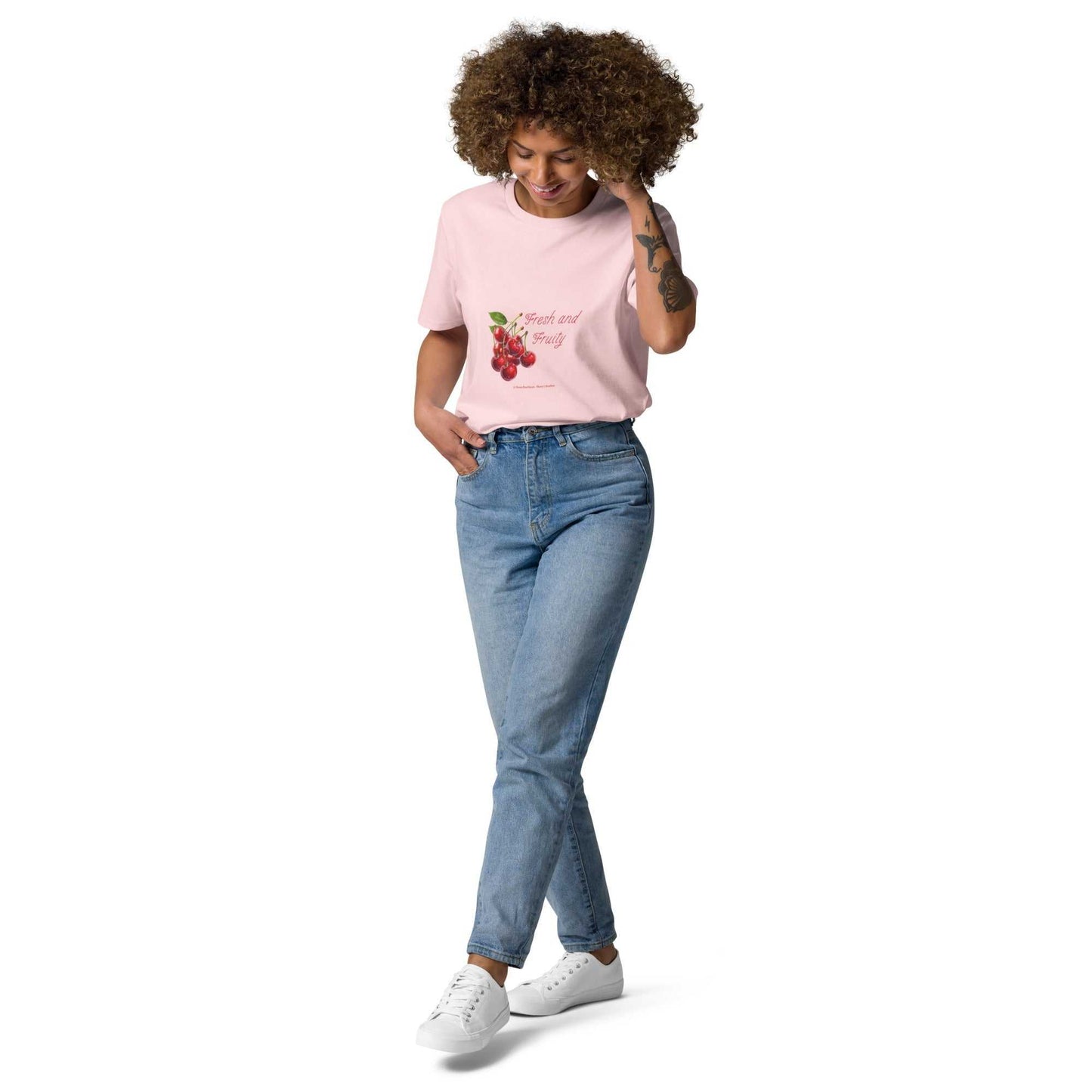 Fresh and Fruity Organic Cotton T-Shirt in pastel pink, styled with jeans. Features eco-friendly cherry design for a cheeky look.