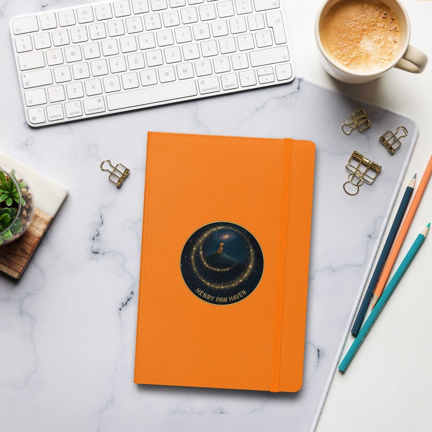 Orange Hardcover Bound Notebook 5.5" × 8.5" with elastic band and HenryPawHaven logo, perfect for writing and planning at your workspace.
