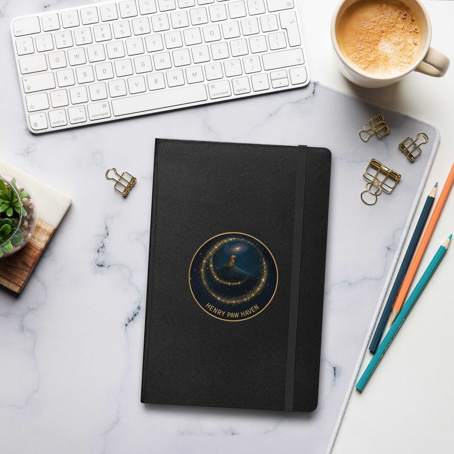 Black Hardcover Bound Notebook 5.5" × 8.5" with elastic closure and HenryPawHaven logo, shown on a desk setup with coffee and stationery.