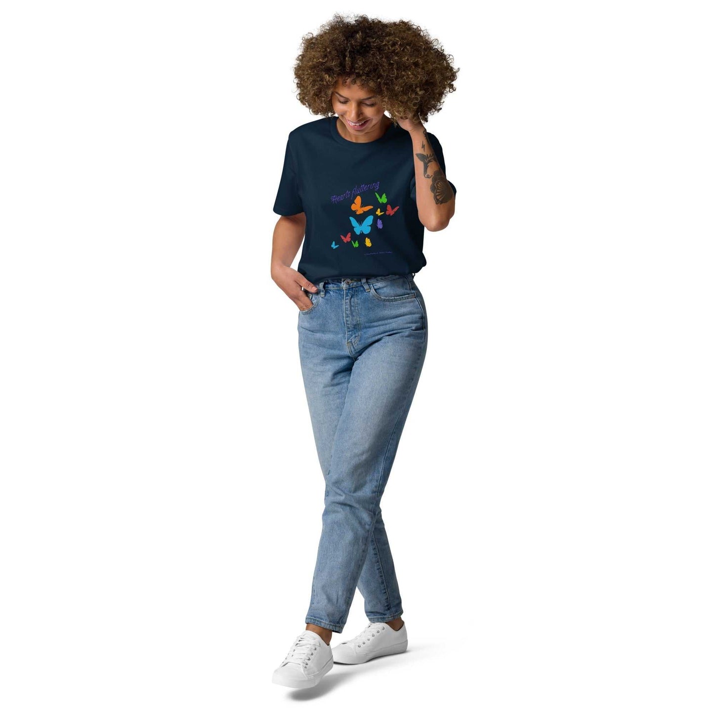 Hearts Fluttering T-Shirt - unisex organic cotton t-shirt in navy blue with colorful butterflies, styled with jeans for a fresh spring look.