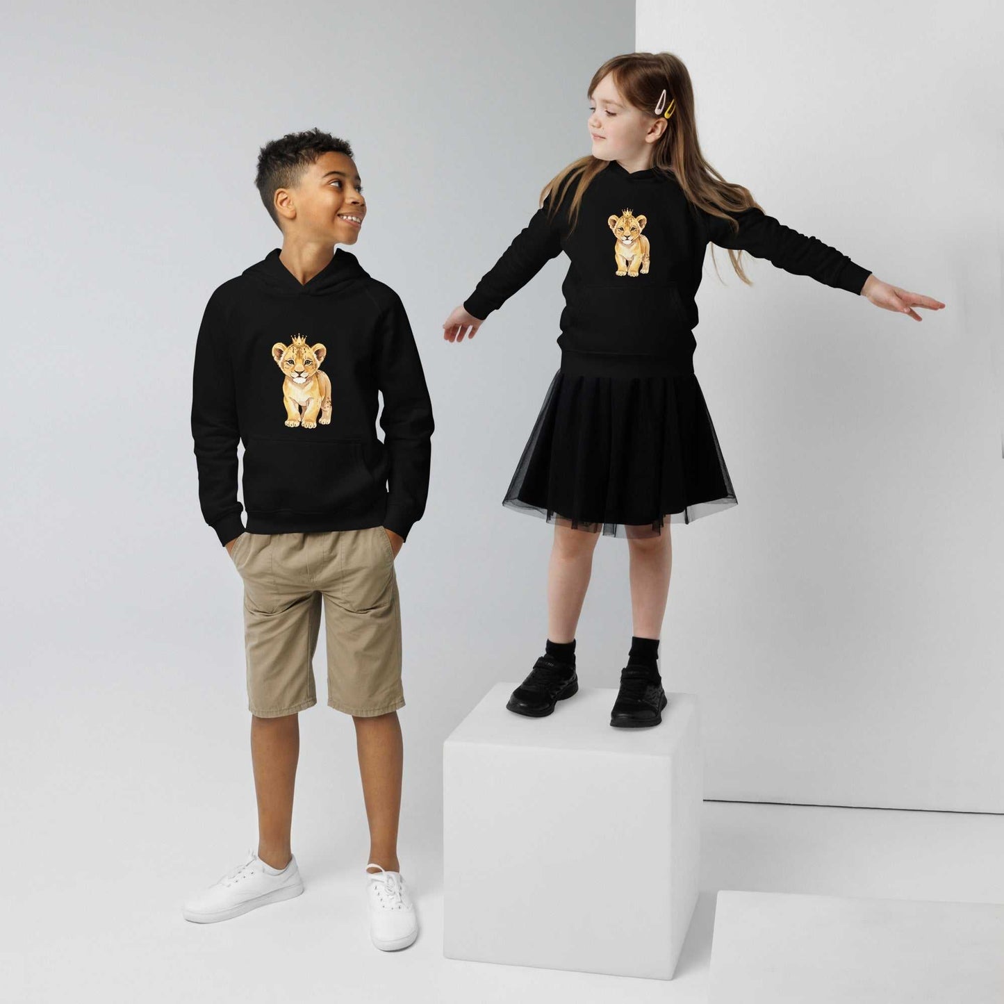 Boy and girl in black kids eco hoodies with baby lion design. Matching organic cotton hoodies for siblings or friends.