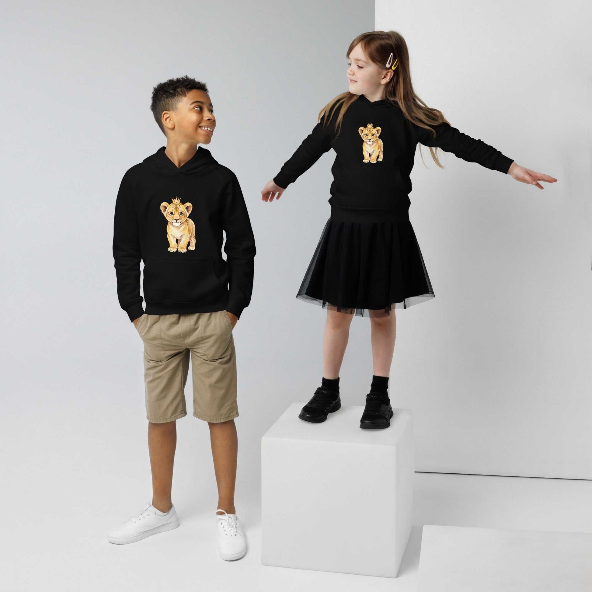 Boy and girl in black kids eco hoodies with baby lion design. Matching organic cotton hoodies for siblings or friends.