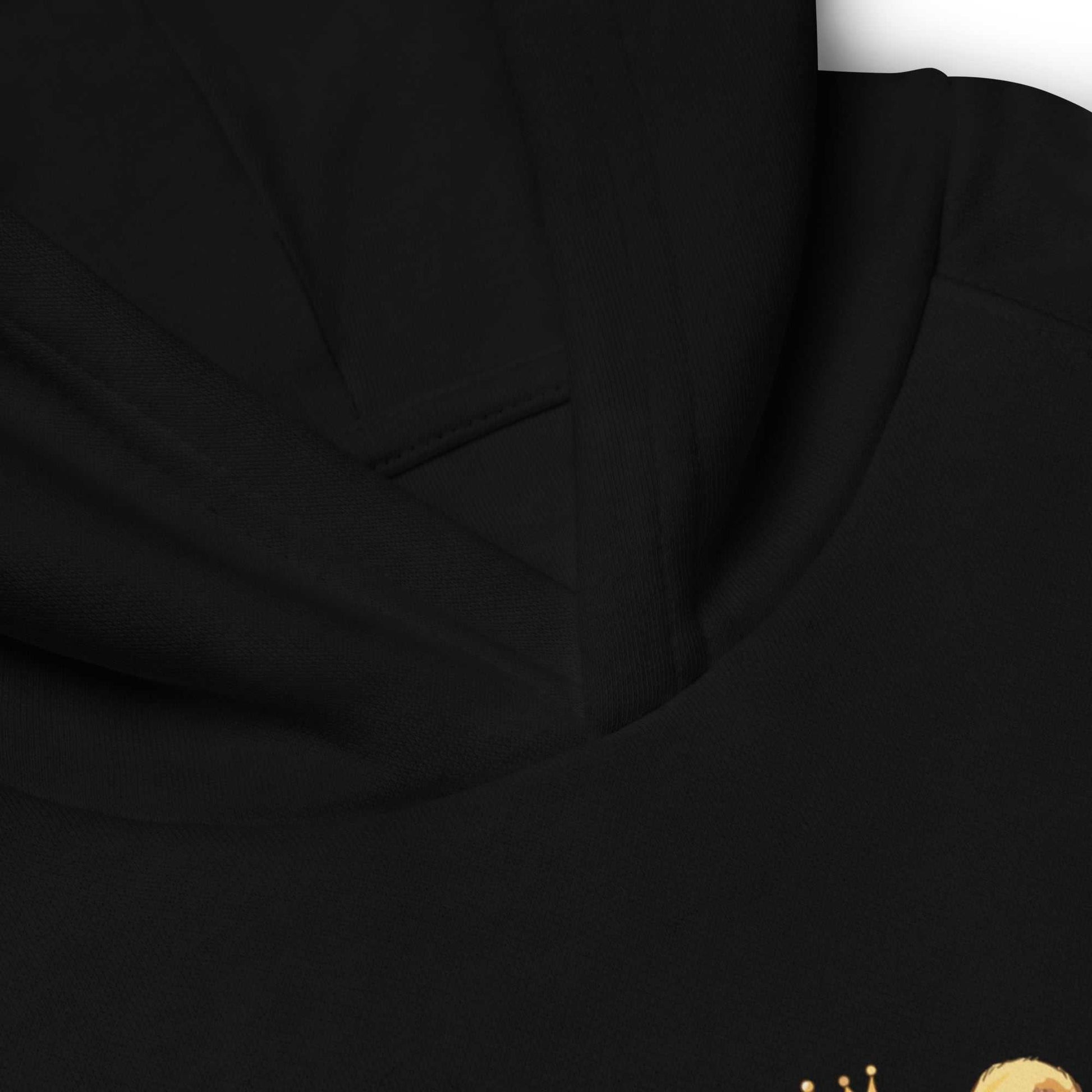Close-up of black kids eco hoodie neckline with baby lion design. Features soft organic cotton and quality stitching.