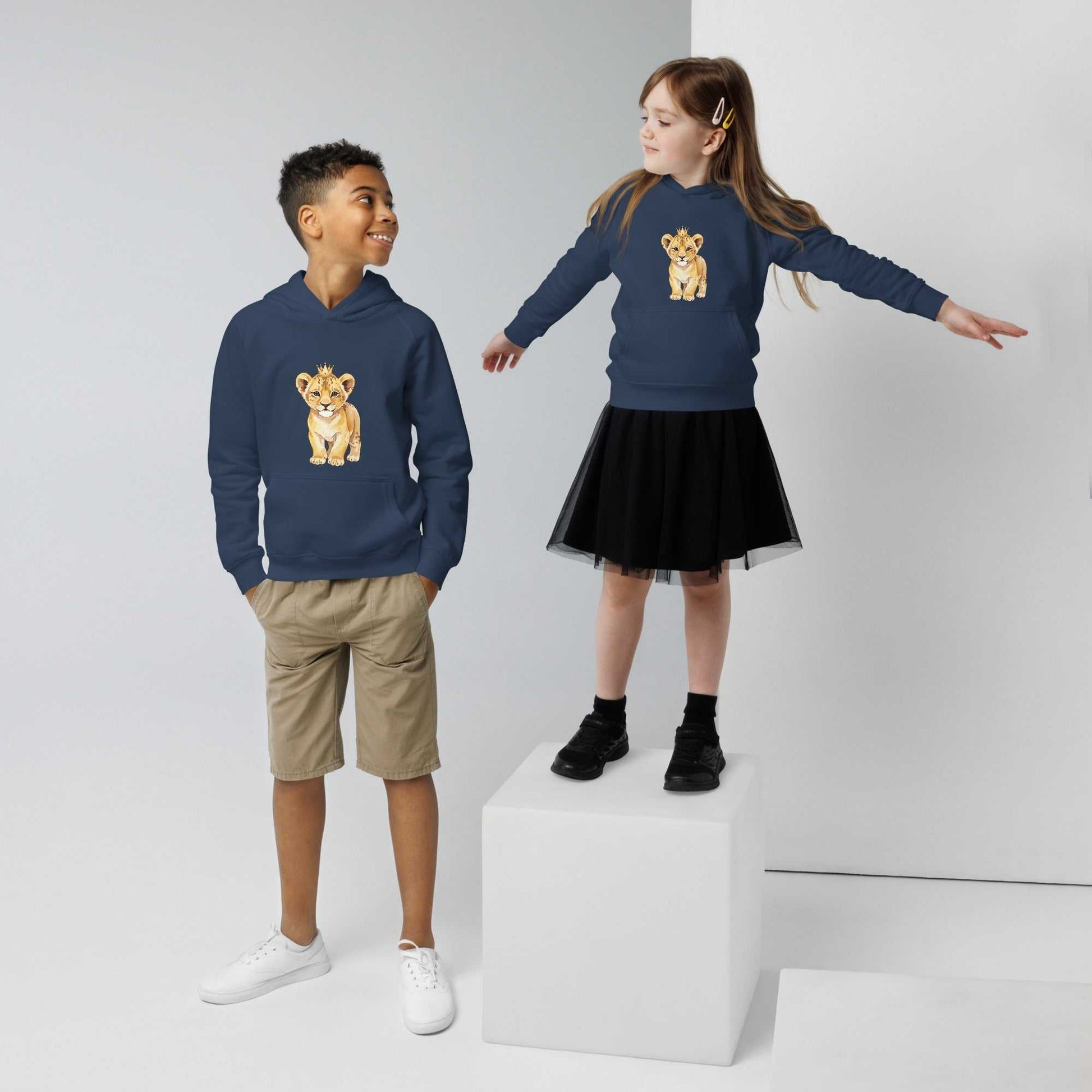 Boy and girl in navy blue kids eco hoodies with baby lion design. Eco-friendly hoodies made from organic cotton for kids.