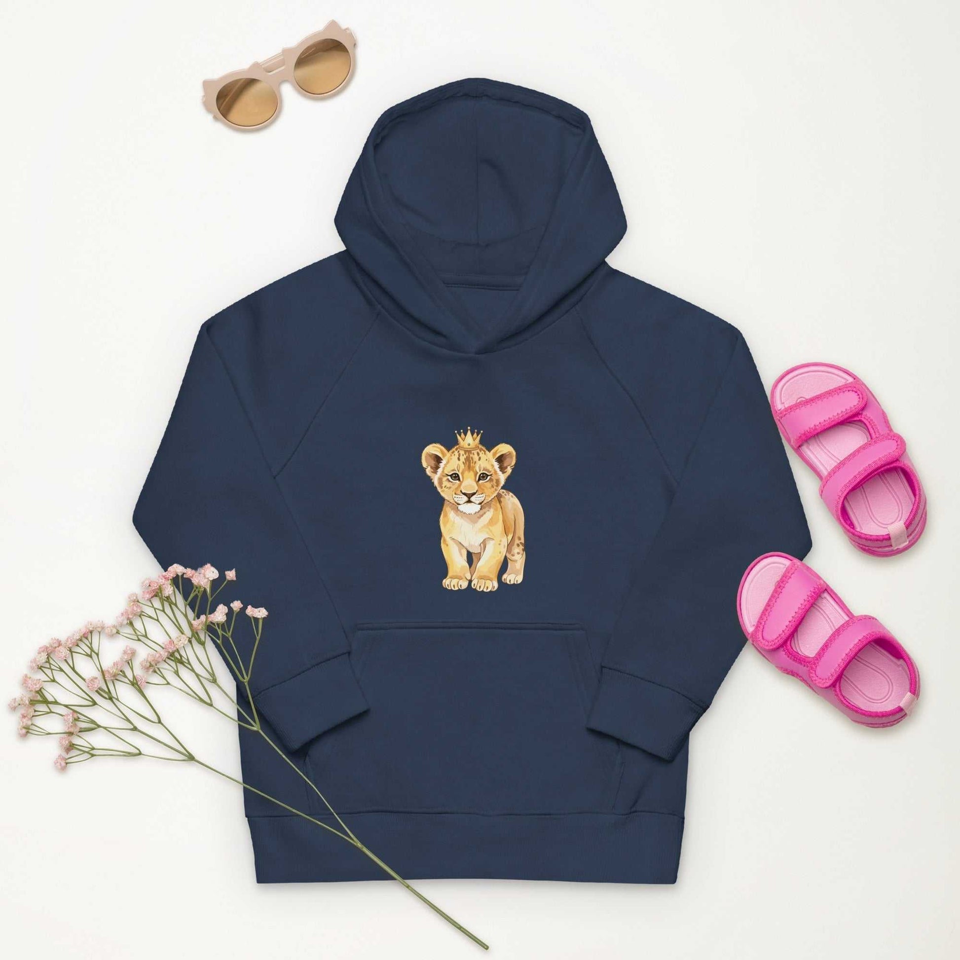 Navy Kids Eco Hoodie with baby lion print, laid flat with pink sandals and sunglasses, ideal for eco-conscious children's fashion.