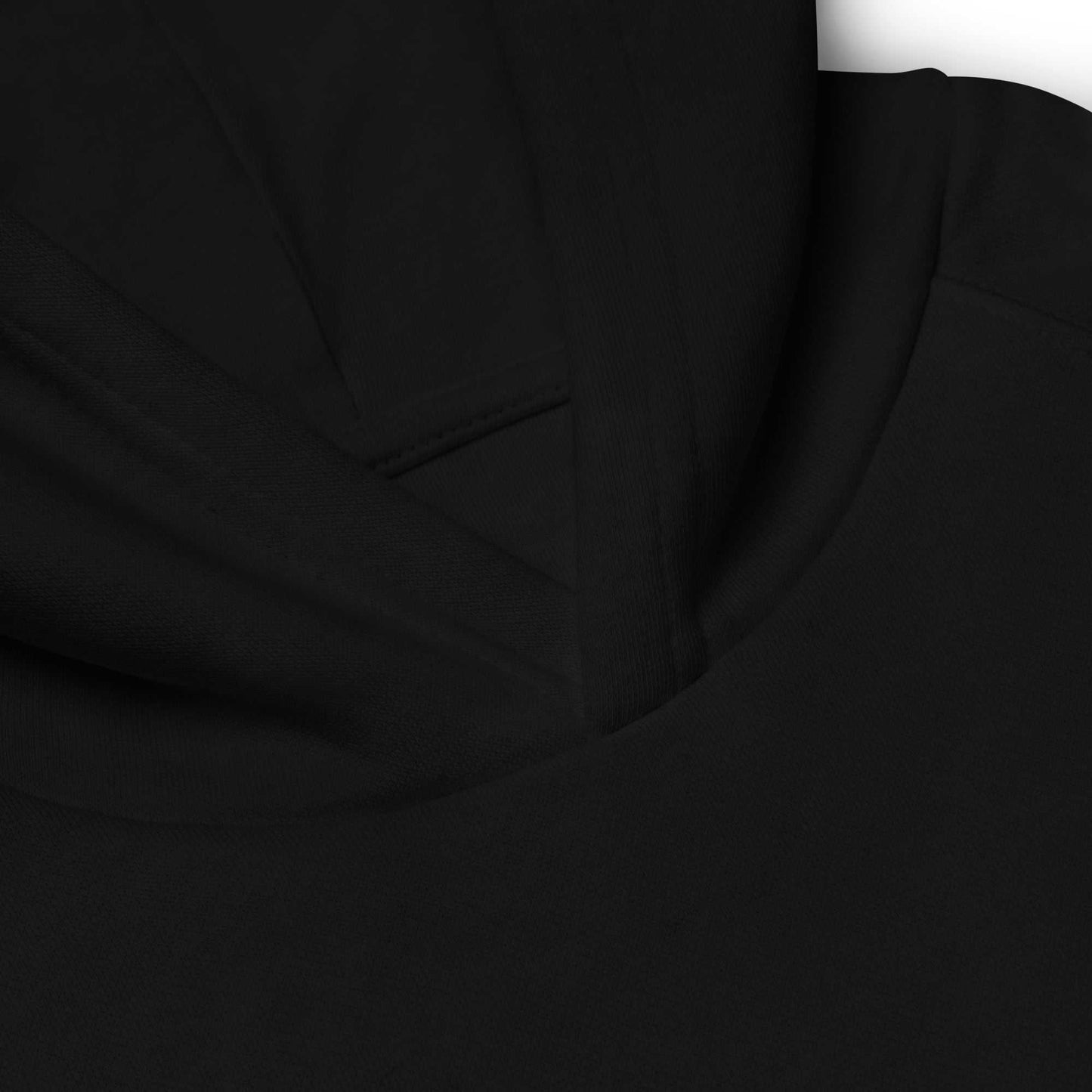 Close-up of black kids eco hoodie hood seam. High-quality organic cotton fabric for durability and comfort.