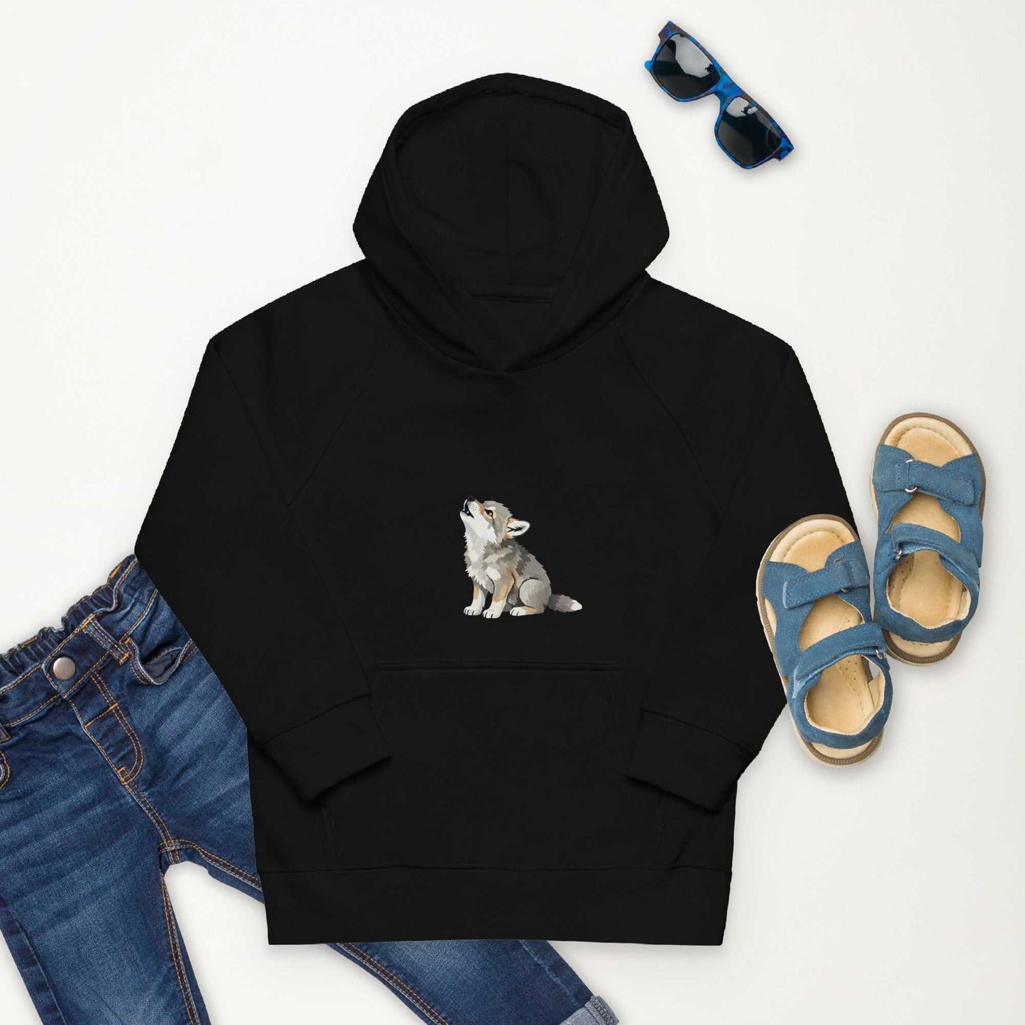 Black kids eco hoodie with baby wolf design, styled with jeans and sandals. Organic cotton hoodie for sustainable kidswear.