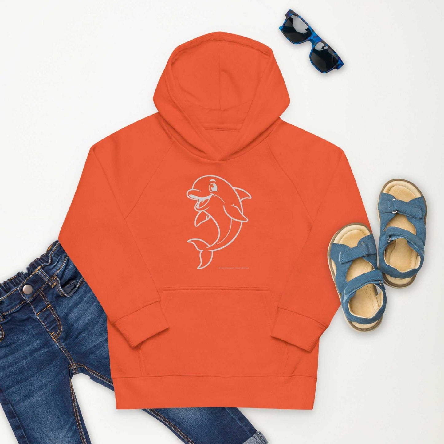 Flat lay of orange Kids Eco Hoodie Dolphin featuring dolphin print, styled with jeans and sandals. Sustainable apparel for kids.