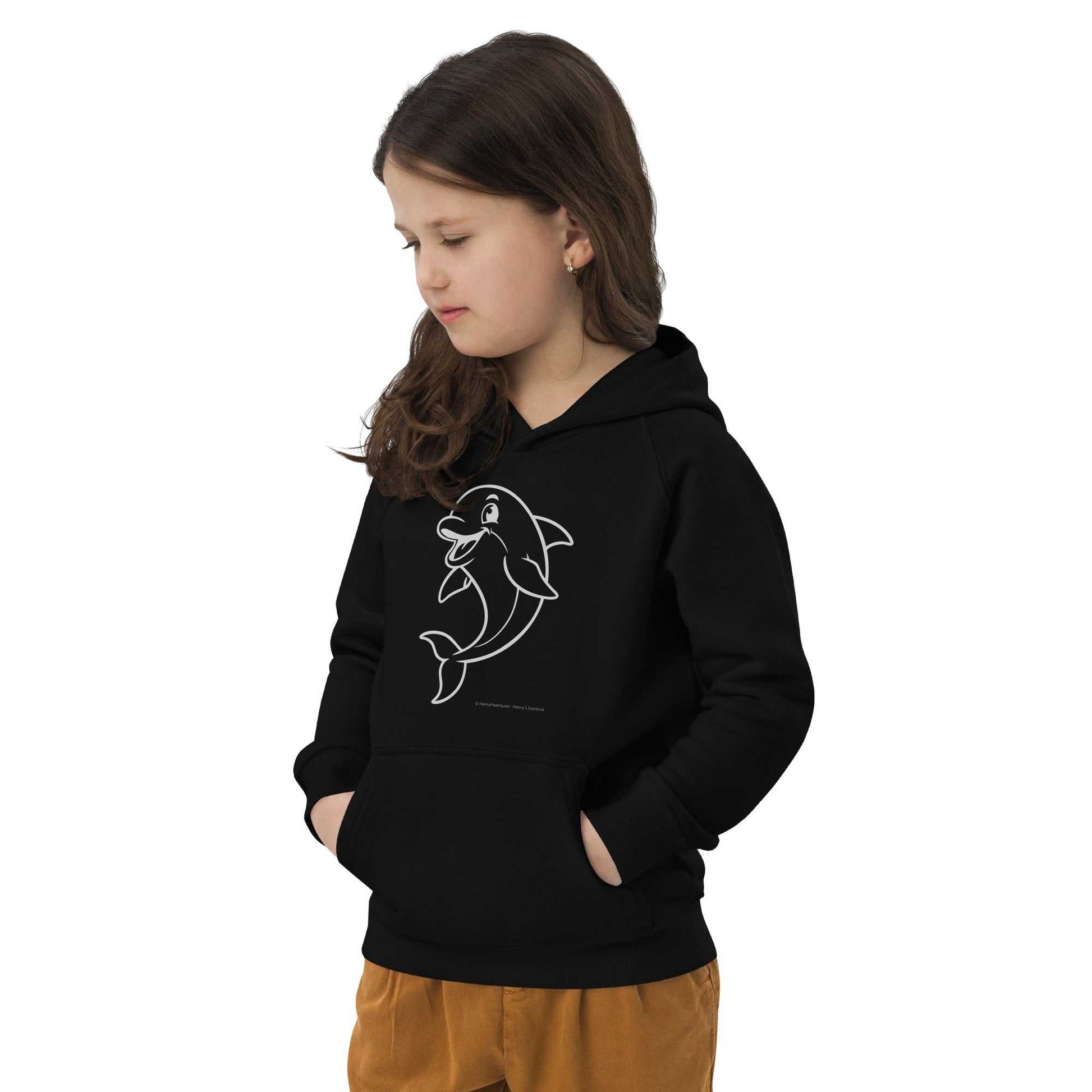 Child wearing black Kids Eco Hoodie Dolphin with hands in pockets. Organic and recycled materials for sustainable kids apparel.