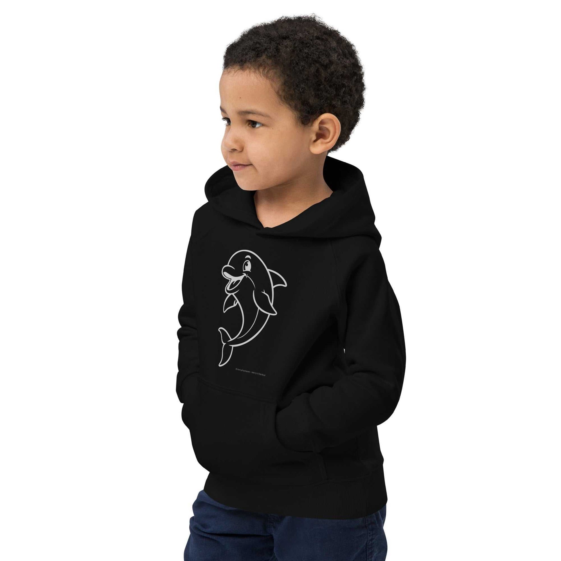 Boy wearing black Kids Eco Hoodie Dolphin with dolphin design, hands in pockets. Organic cotton hoodie for kids' everyday wear.