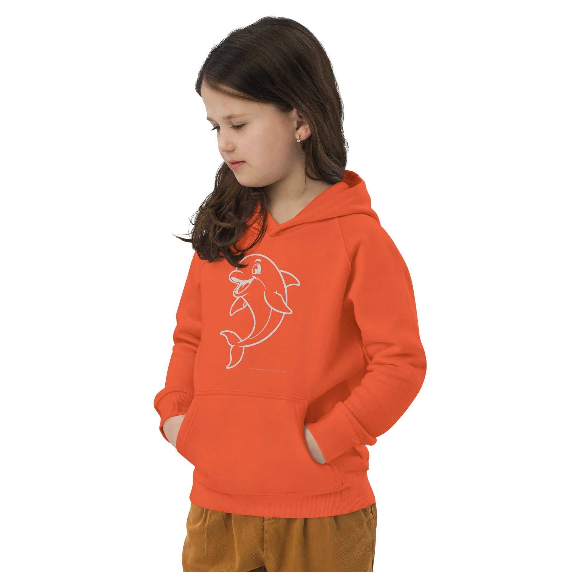 Child wearing orange Kids Eco Hoodie Dolphin with dolphin design, hands in pockets. Sustainable hoodie for active kids.