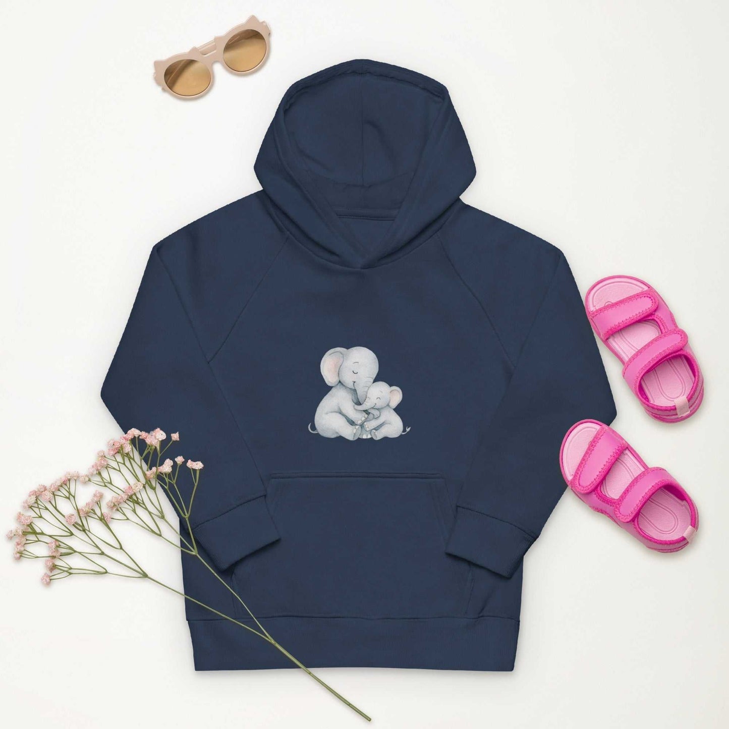 Navy Kids Eco Hoodie featuring a cute Mom & Baby Elephant print, laid flat with pink sandals and sunglasses for a playful outfit idea.