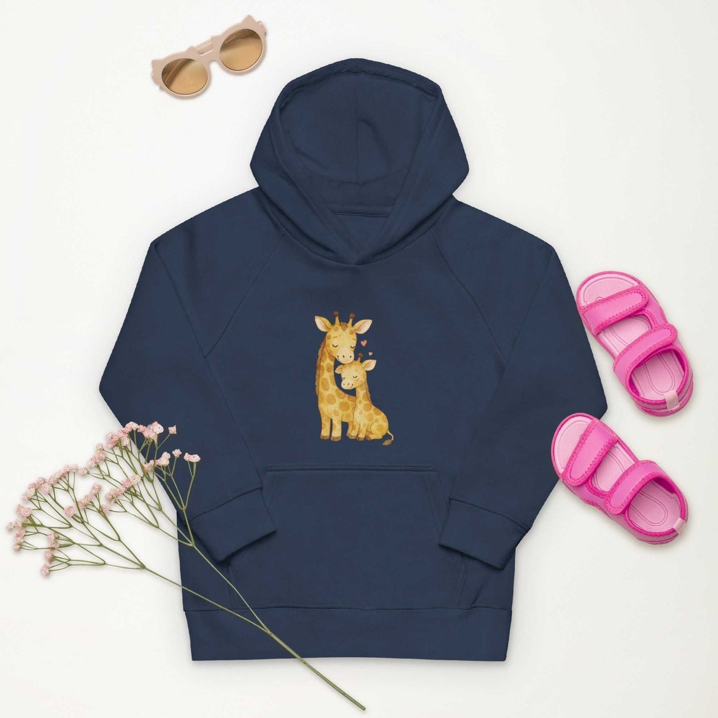 Navy kids eco hoodie with mom & baby giraffe print, styled with pink sandals and sunglasses. Organic cotton hoodie in kids activewear.