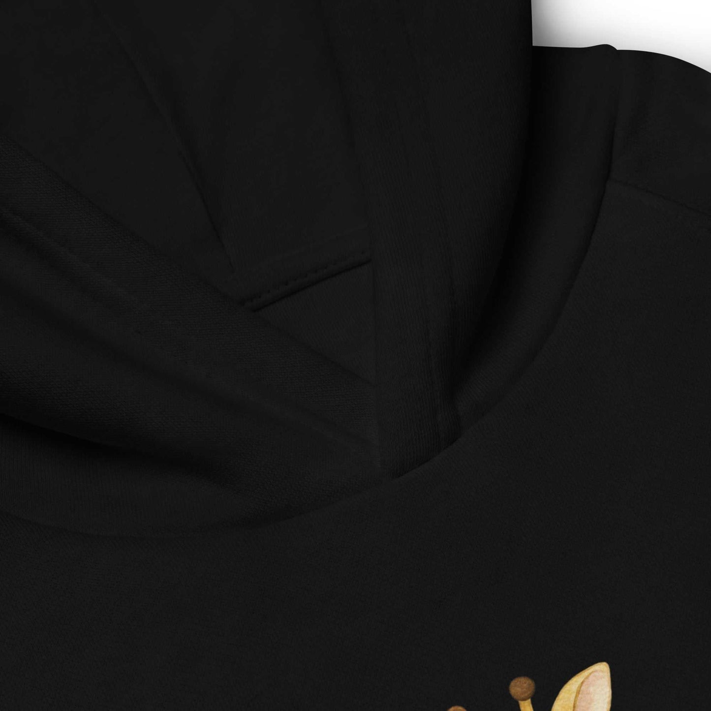 Close-up of black kids eco hoodie showing detailed stitching and hood seam. High-quality organic cotton hoodie with giraffe design.
