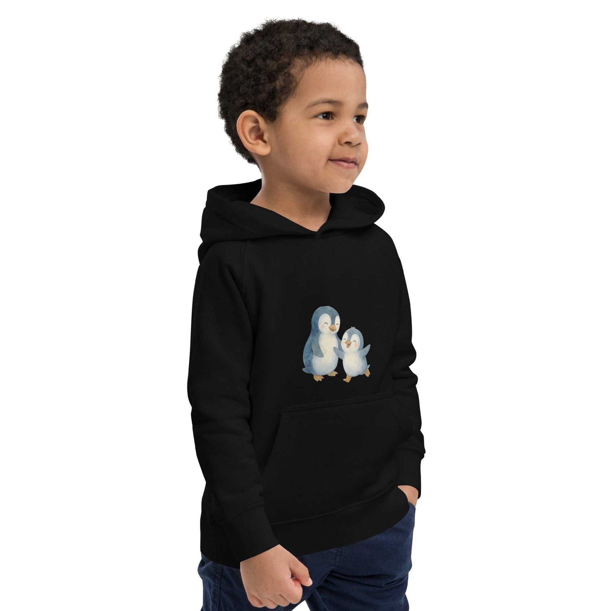 Side view of black organic cotton kids hoodie featuring playful penguin print, soft and sustainable fabric perfect for everyday wear.
