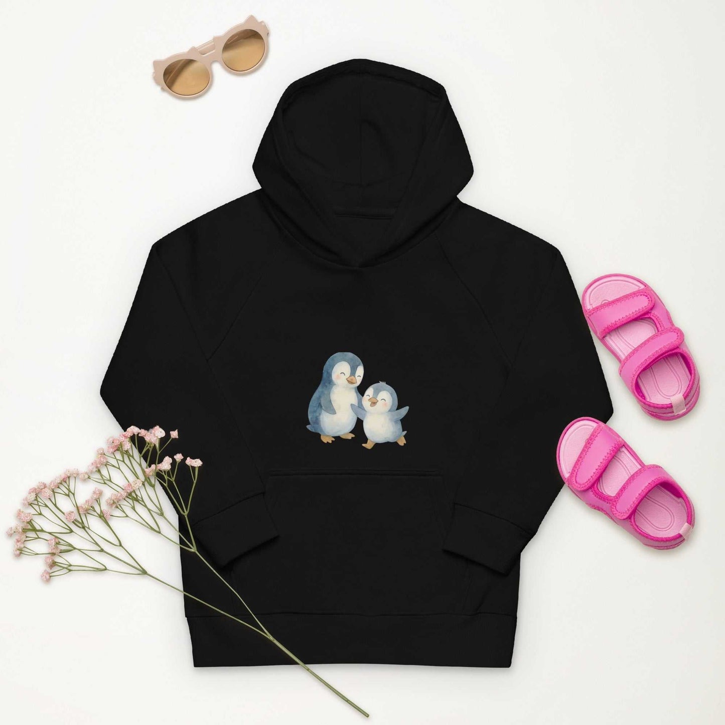 Black Organic Cotton Kids Hoodie with penguin design, styled with pink sandals and sunglasses for a fun eco look