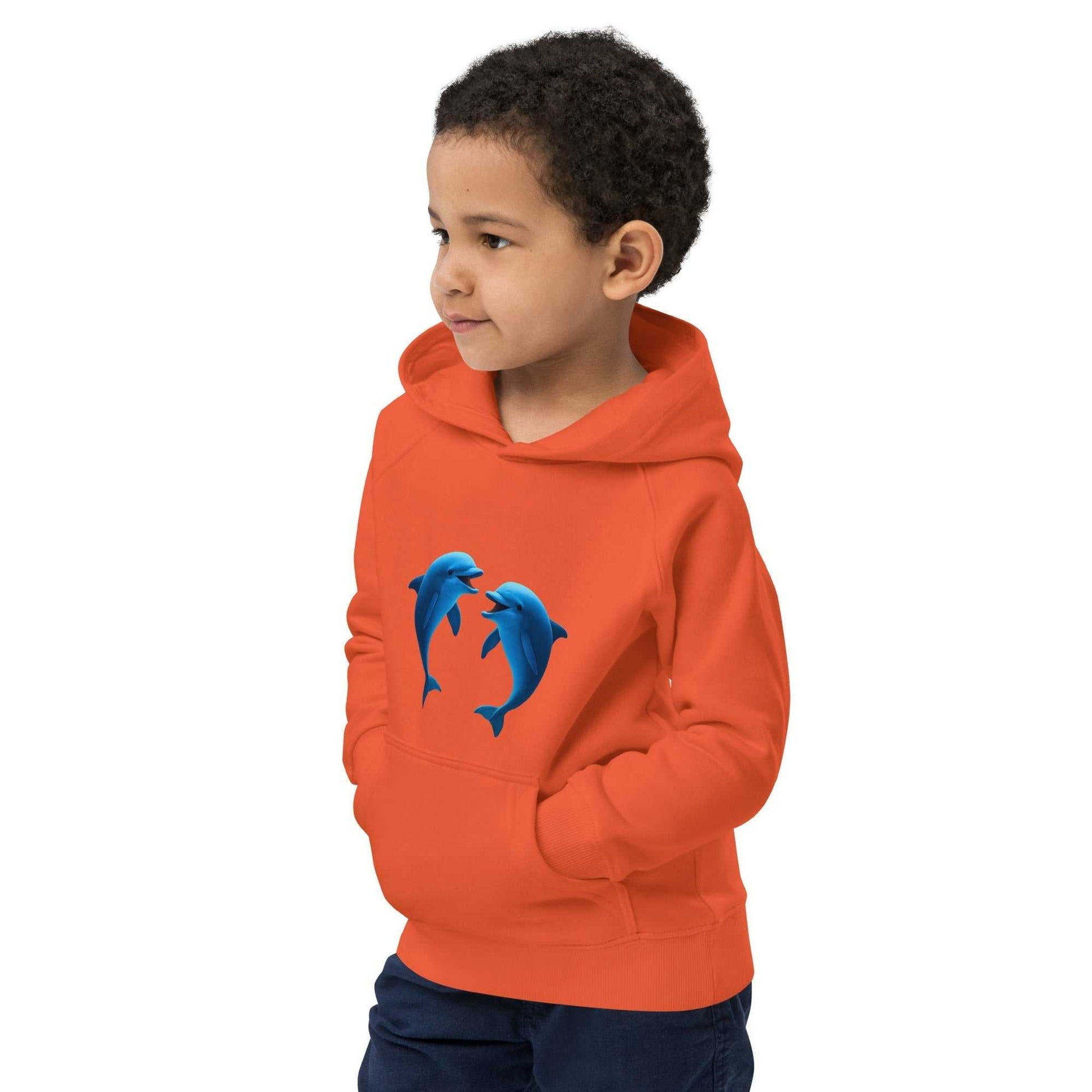 Child in orange eco dolphin hoodie made from organic cotton. Sustainable and comfortable activewear for kids who love the ocean.