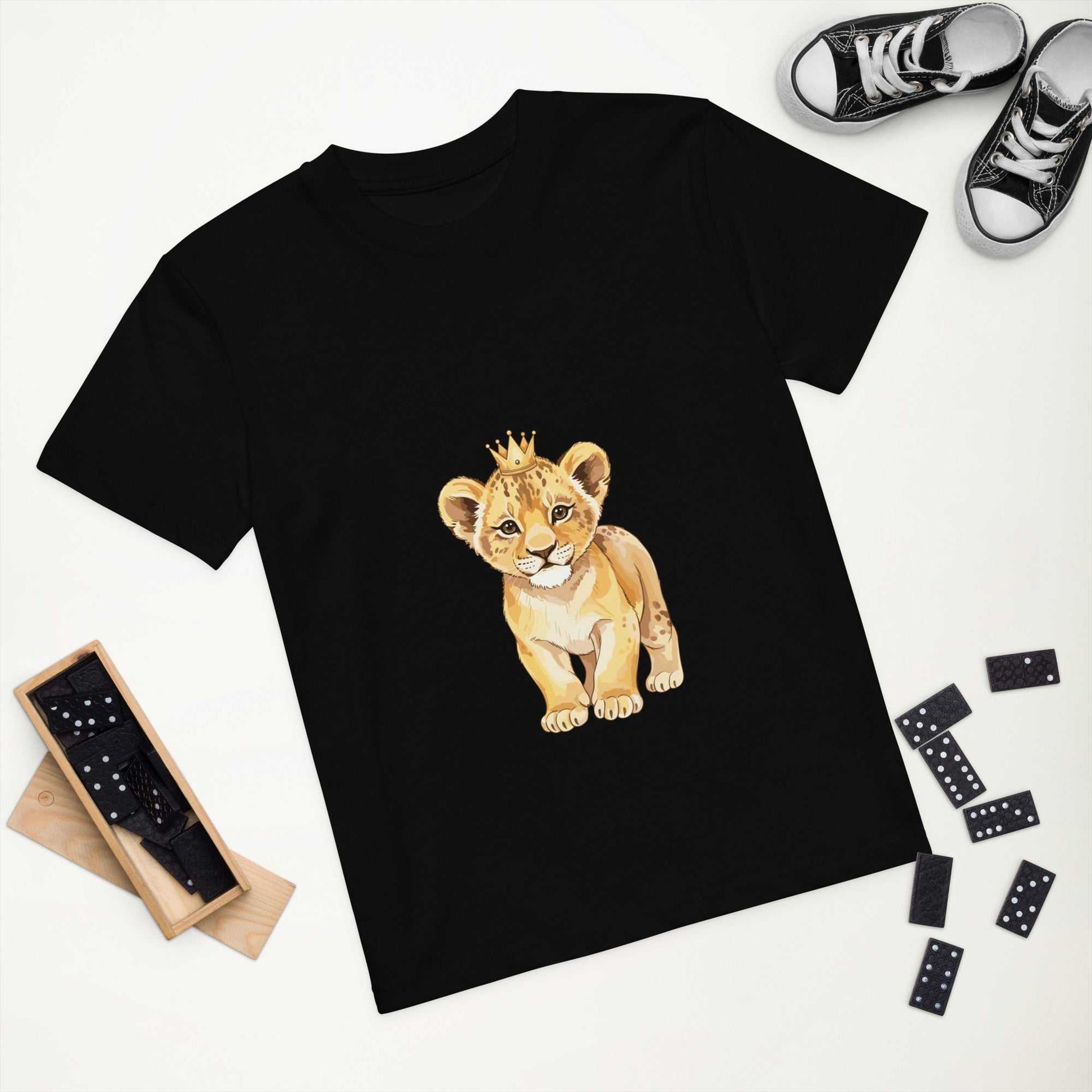 Black kids eco t-shirt with baby lion print displayed flat with accessories, GOTS certified for sustainable children's clothing.