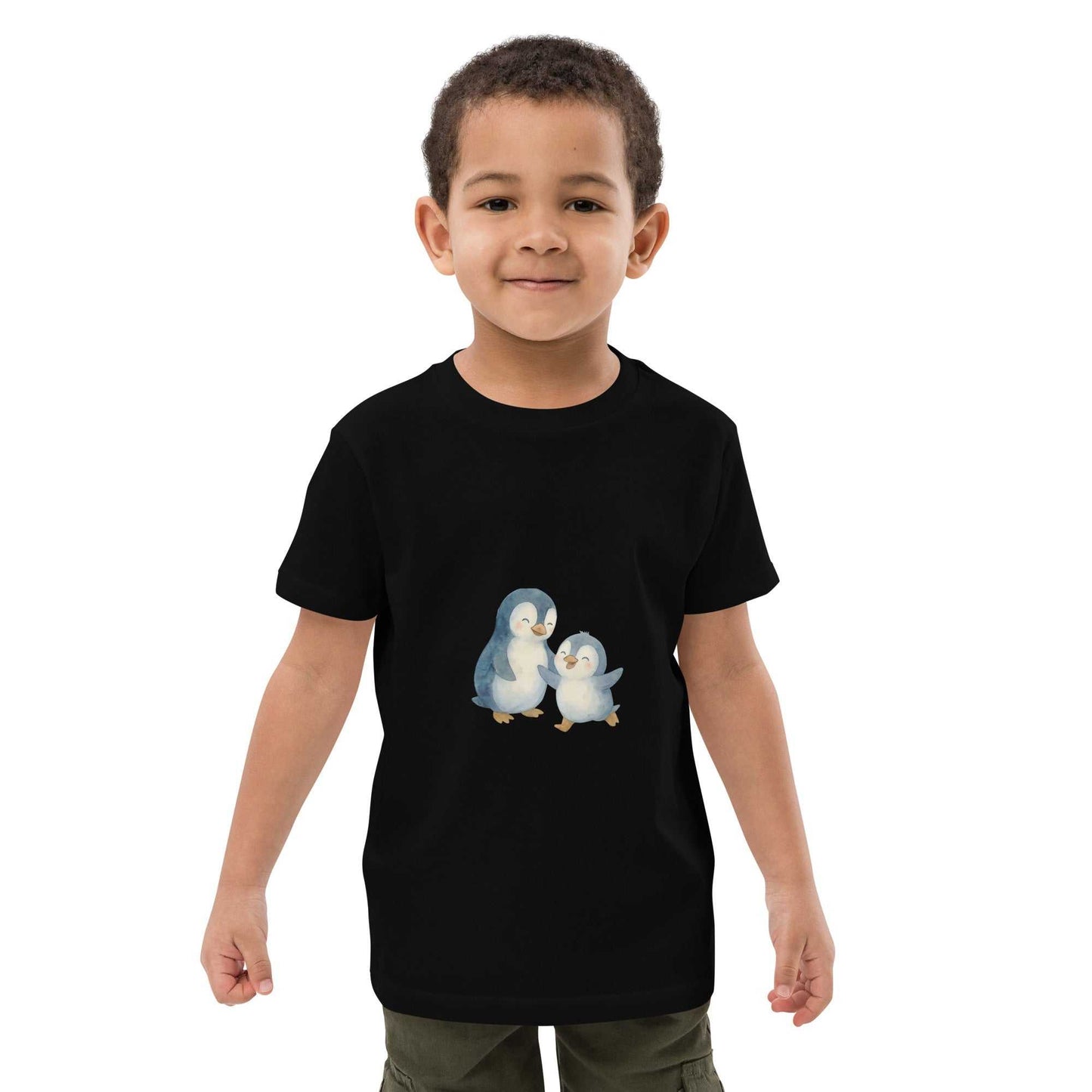 Black kids organic cotton penguin t-shirt featuring cute penguin print, modeled by boy. Eco-friendly and GOTS certified fabric.