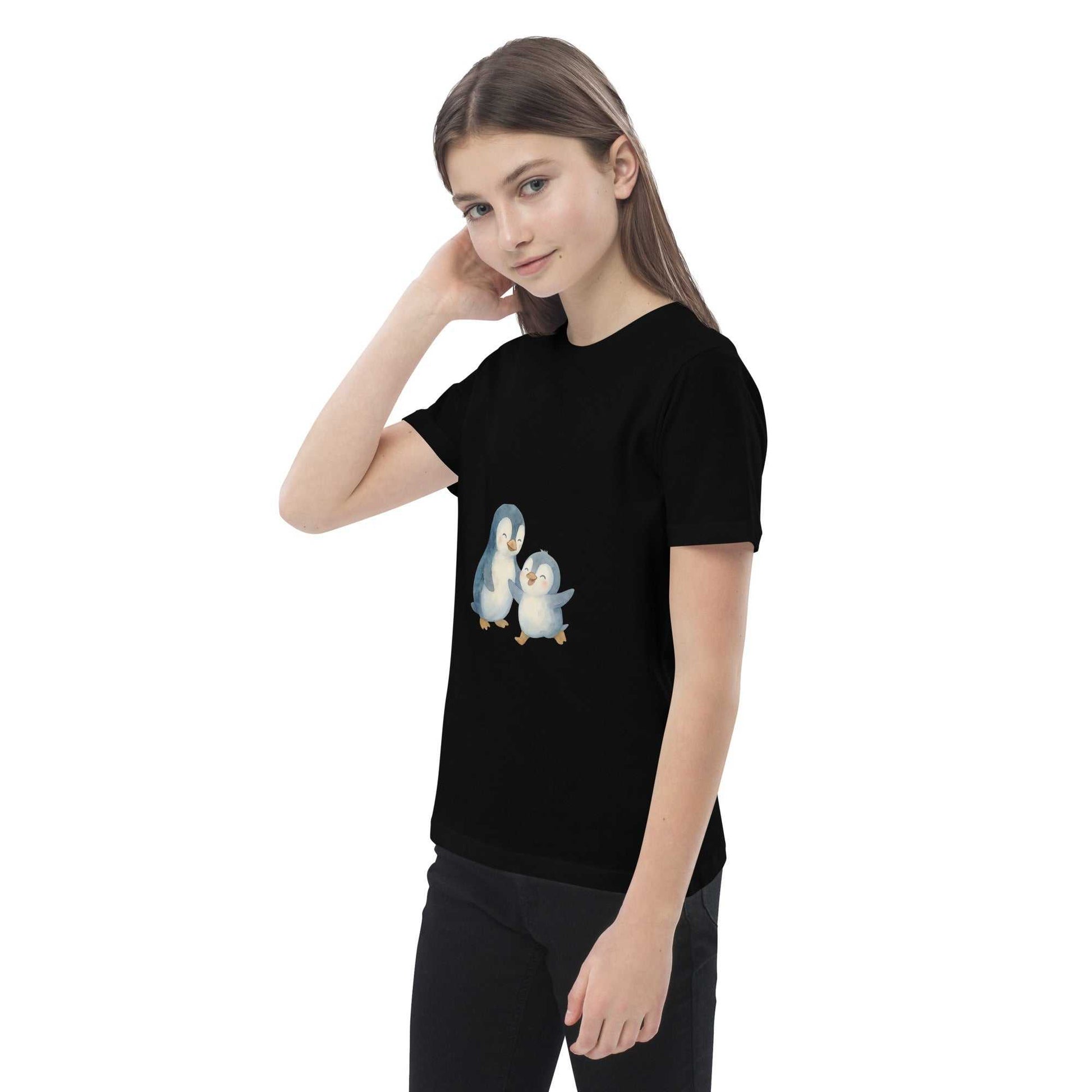 Girl posing in black Kids Organic Cotton Penguin T-Shirt with sustainable penguin design, perfect for casual wear.