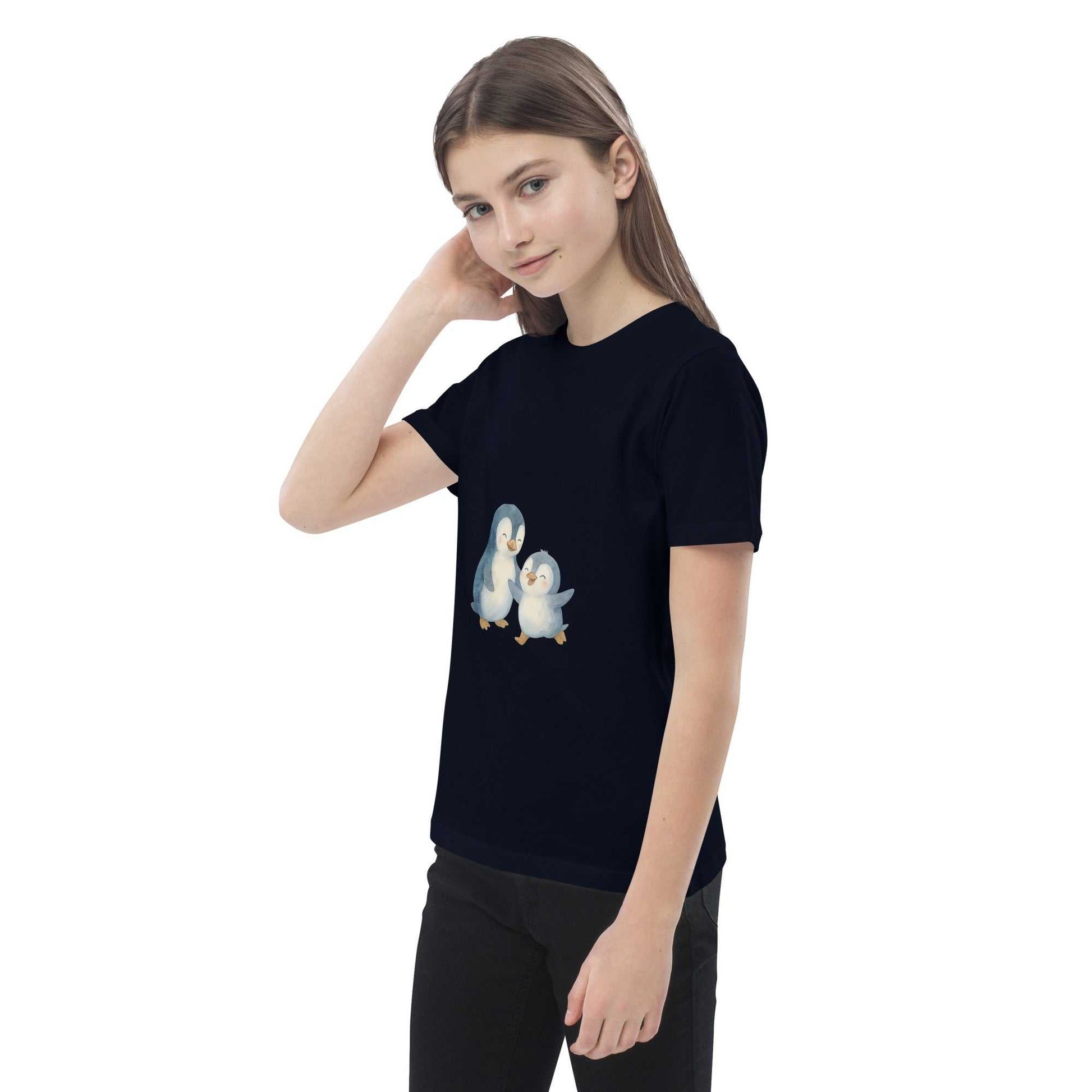 Girl in navy Kids Organic Cotton Penguin T-Shirt with cute penguin print, made from GOTS certified organic cotton.