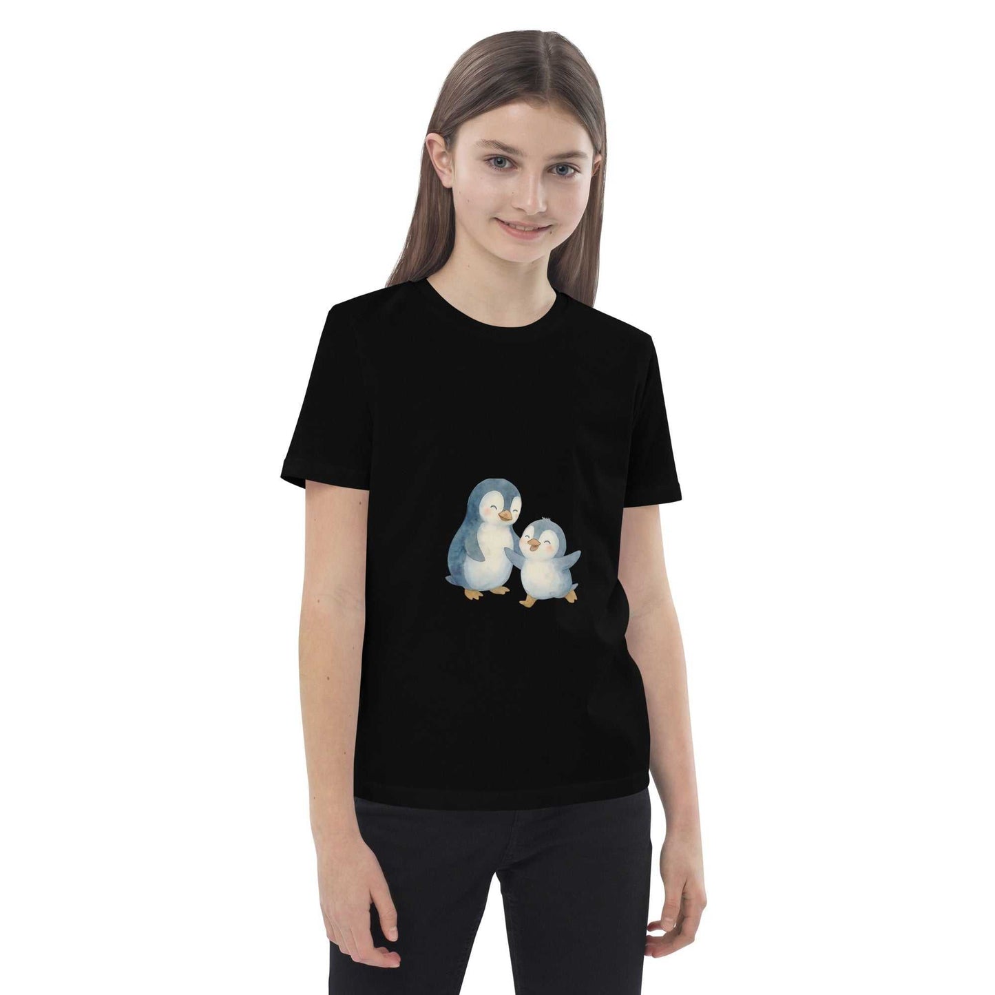Smiling girl wearing black Kids Organic Cotton Penguin T-Shirt with charming penguin design, made from GOTS certified cotton.