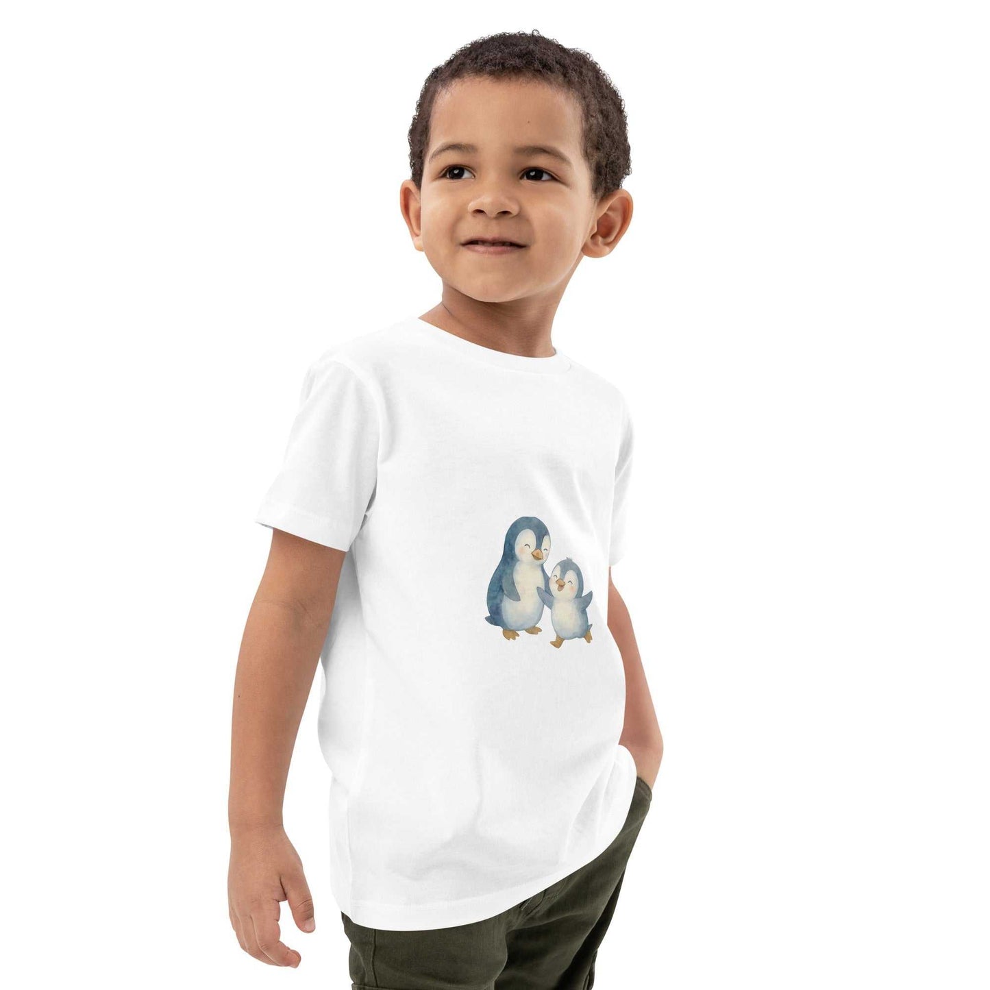 Side view of boy in white kids organic cotton penguin t-shirt. Eco-friendly design with soft GOTS certified cotton.