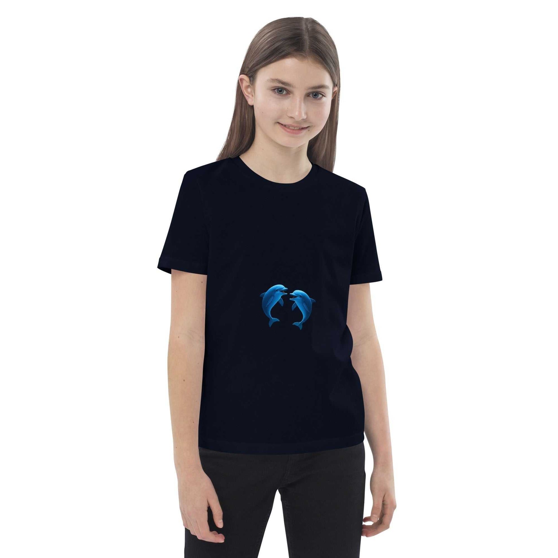 Smiling child in navy Kids Organic Cotton T-Shirt with dolphin design. Eco-friendly and perfect for everyday wear.