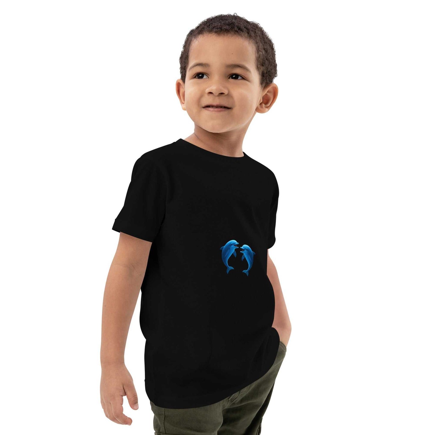 Black Kids Organic Cotton T-Shirt with playful dolphins design, eco-friendly and GOTS certified, modeled by a smiling child.
