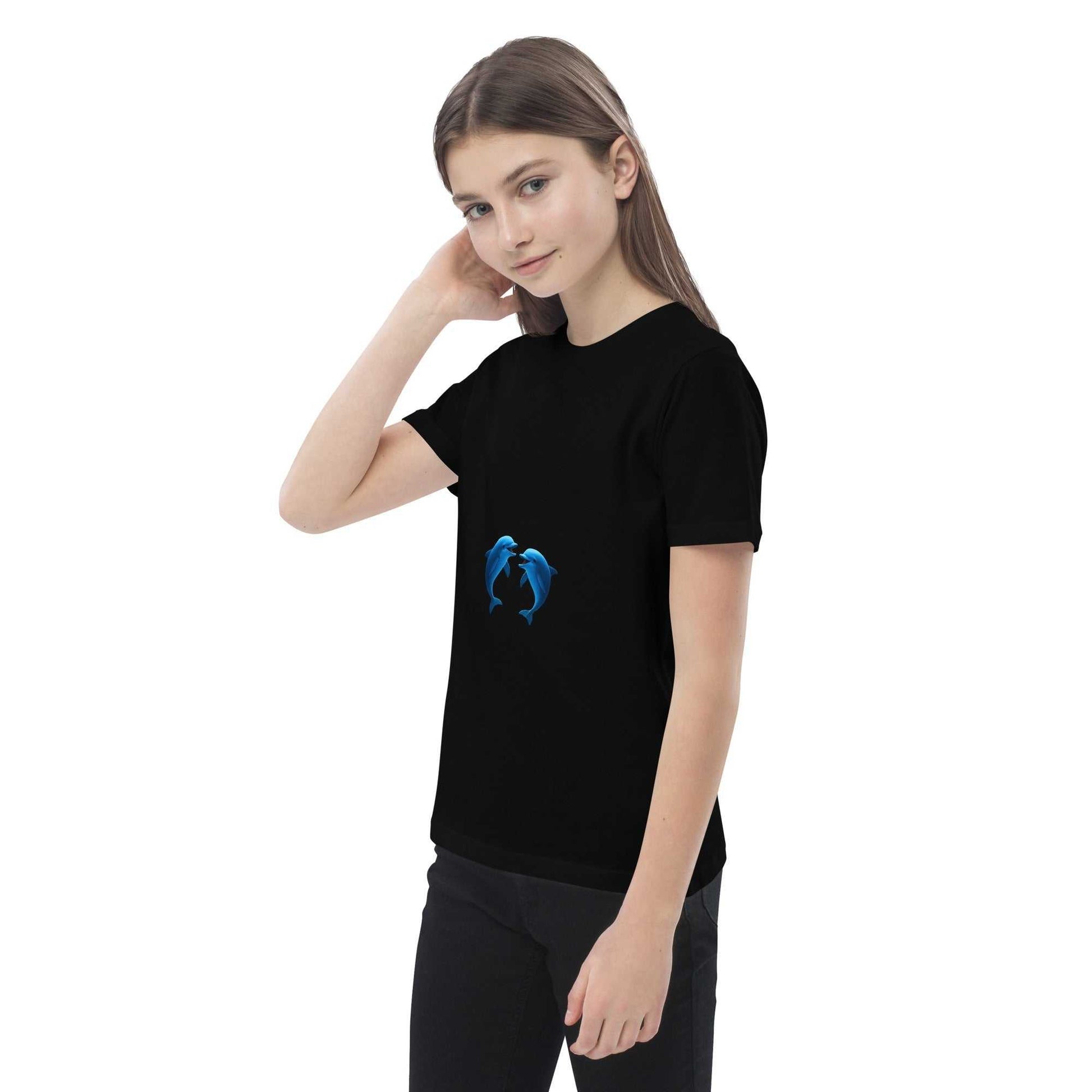 Child in black Kids Organic Cotton T-Shirt with dolphin print. GOTS-certified fabric for sustainable kidswear.