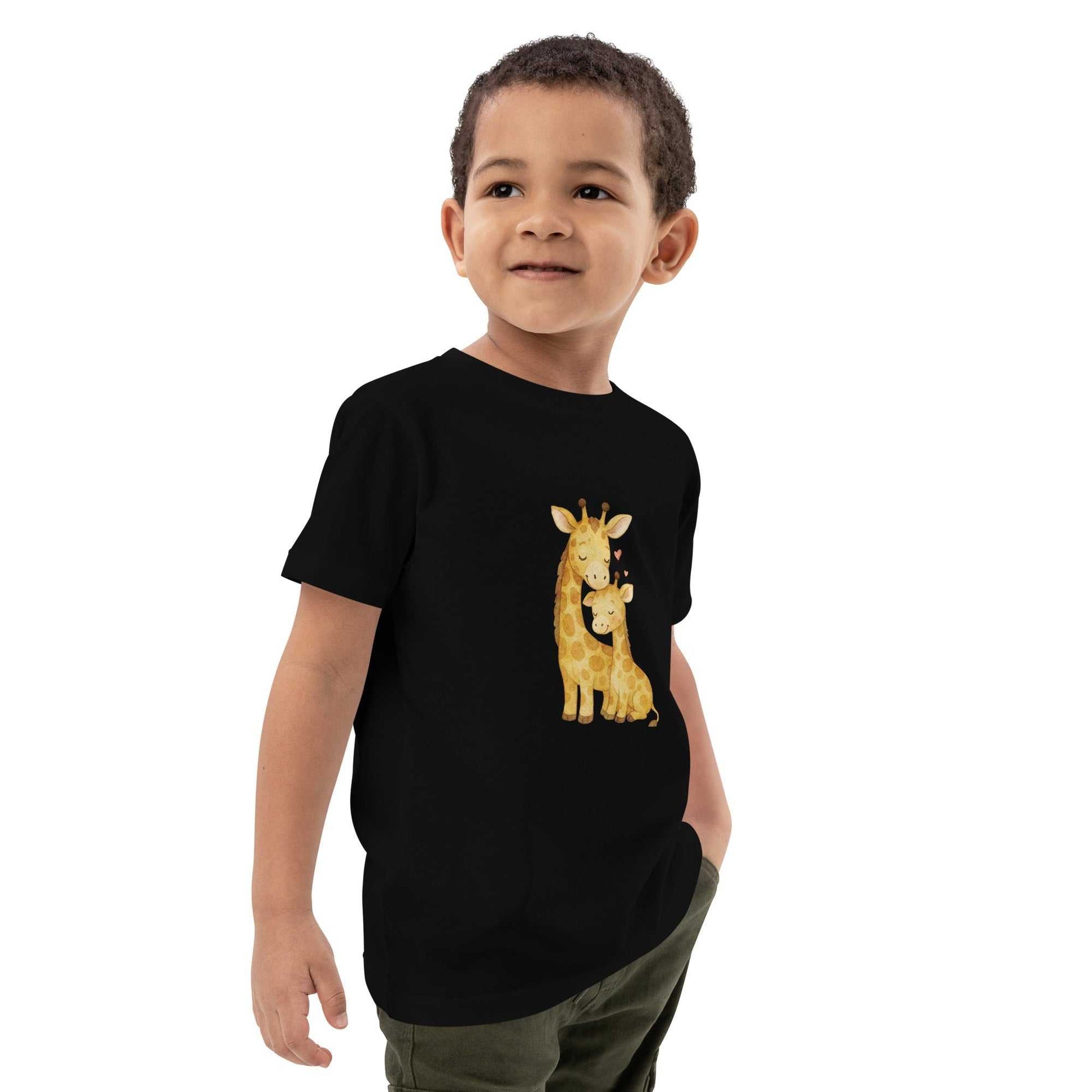Kids Organic Cotton T-Shirt - black t-shirt with cute giraffe print, side view on child model, ideal for everyday comfort and play.