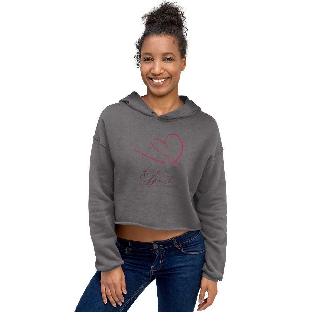 Model in charcoal gray cropped hoodie with red 'Love Expert' heart design. A fashionable and comfortable choice for women's activewear.