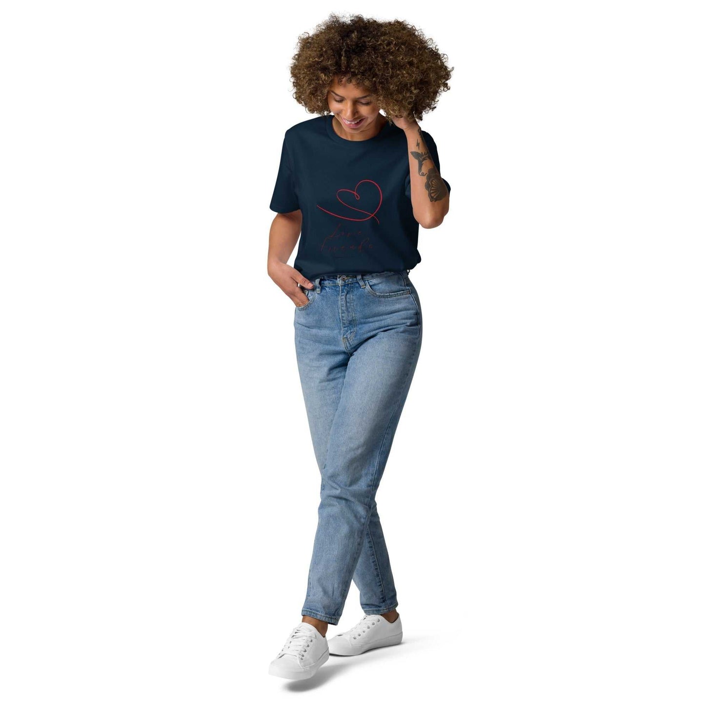 Model in navy Love Friends organic cotton t-shirt with red heart design. Eco-friendly unisex tee styled with jeans for everyday comfort.