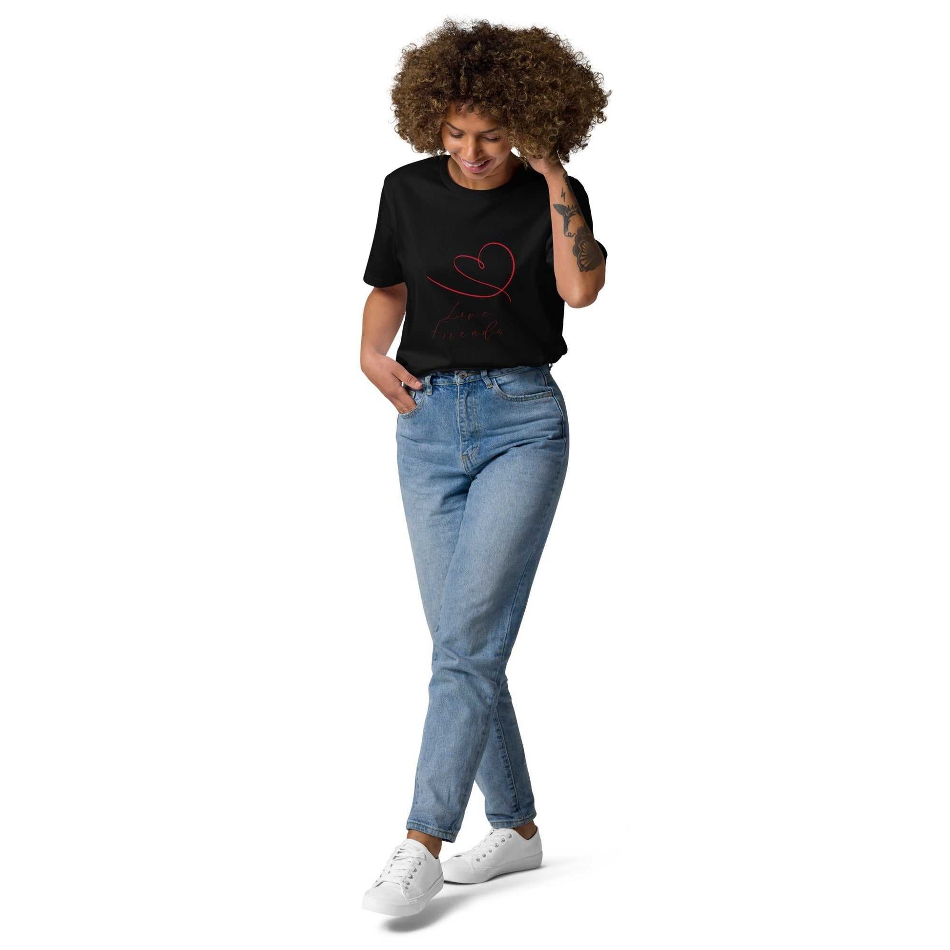 Model wearing black Love Friends organic cotton t-shirt with red heart design. Eco-friendly unisex tee paired with jeans for casual style.