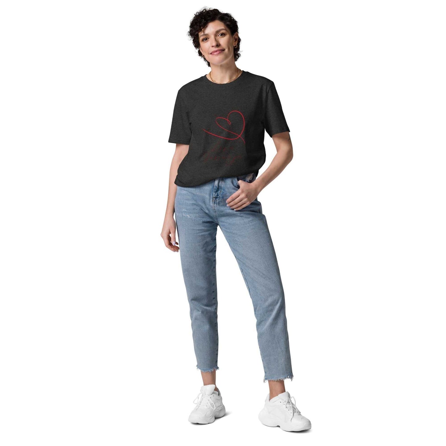 Model in dark heather grey Love Journeys unisex organic cotton t-shirt with red heart design. Ethically made apparel.