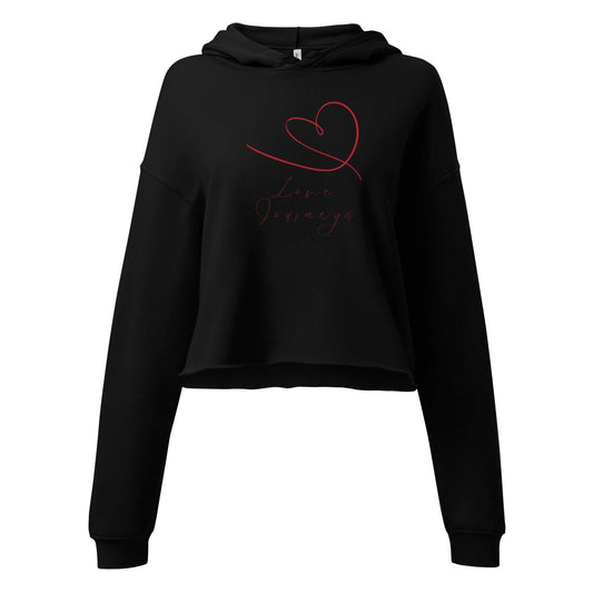 Black womens cropped hoodie love design featuring red heart and 'Love Journeys' script. Hand-drawn graphic on soft cotton blend.