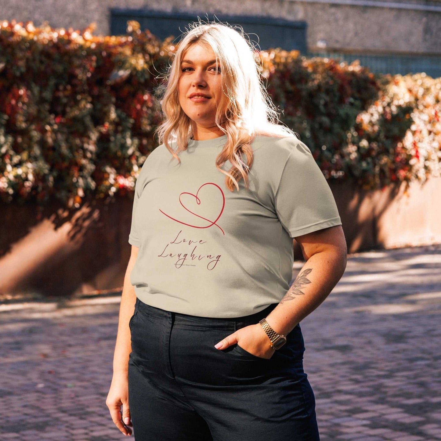 Sage green Love Laughing T-Shirt in organic cotton, unisex fit with minimalist heart graphic for eco-friendly fashion.
