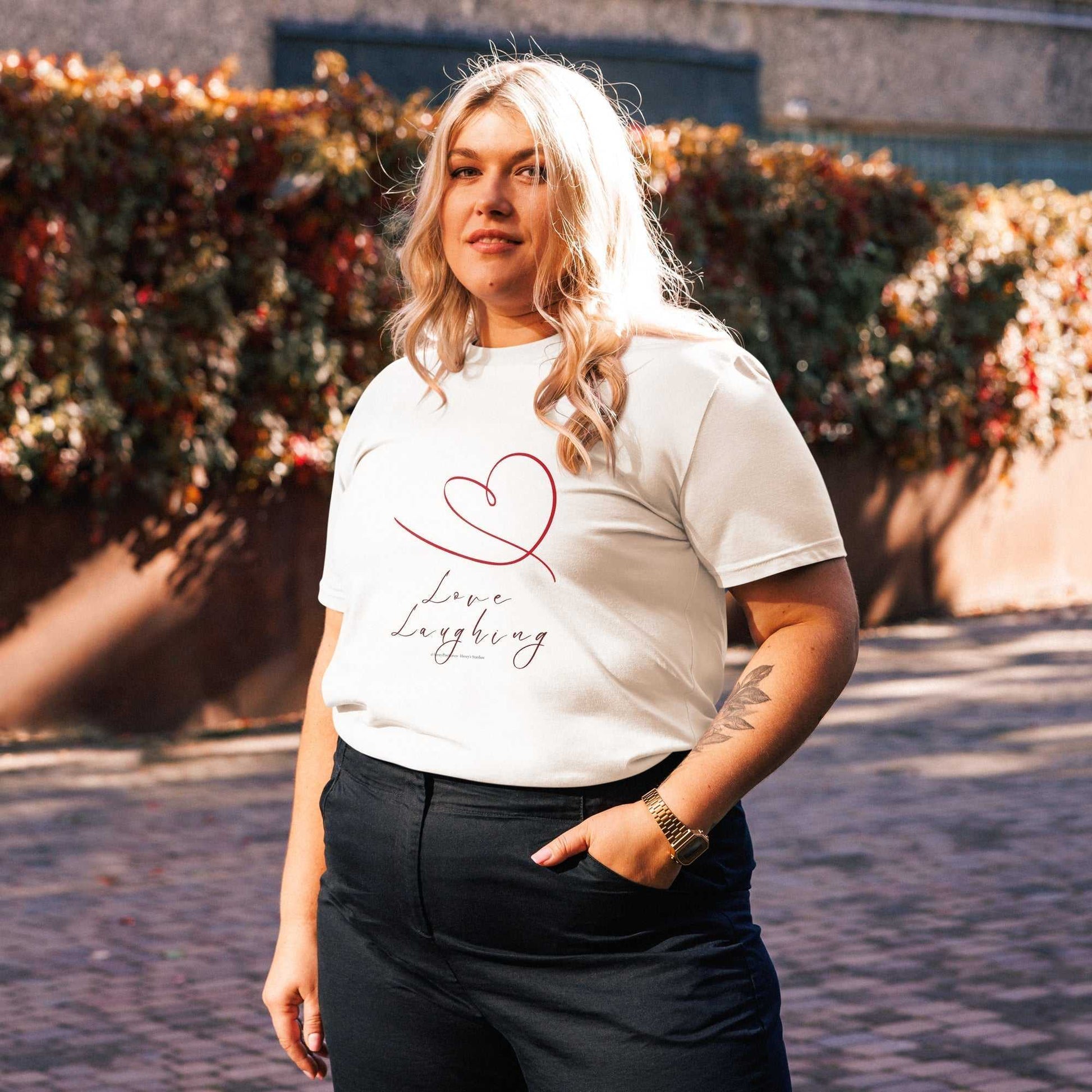 White Love Laughing T-Shirt in organic cotton, unisex fit with red heart and text design for sustainable everyday fashion.