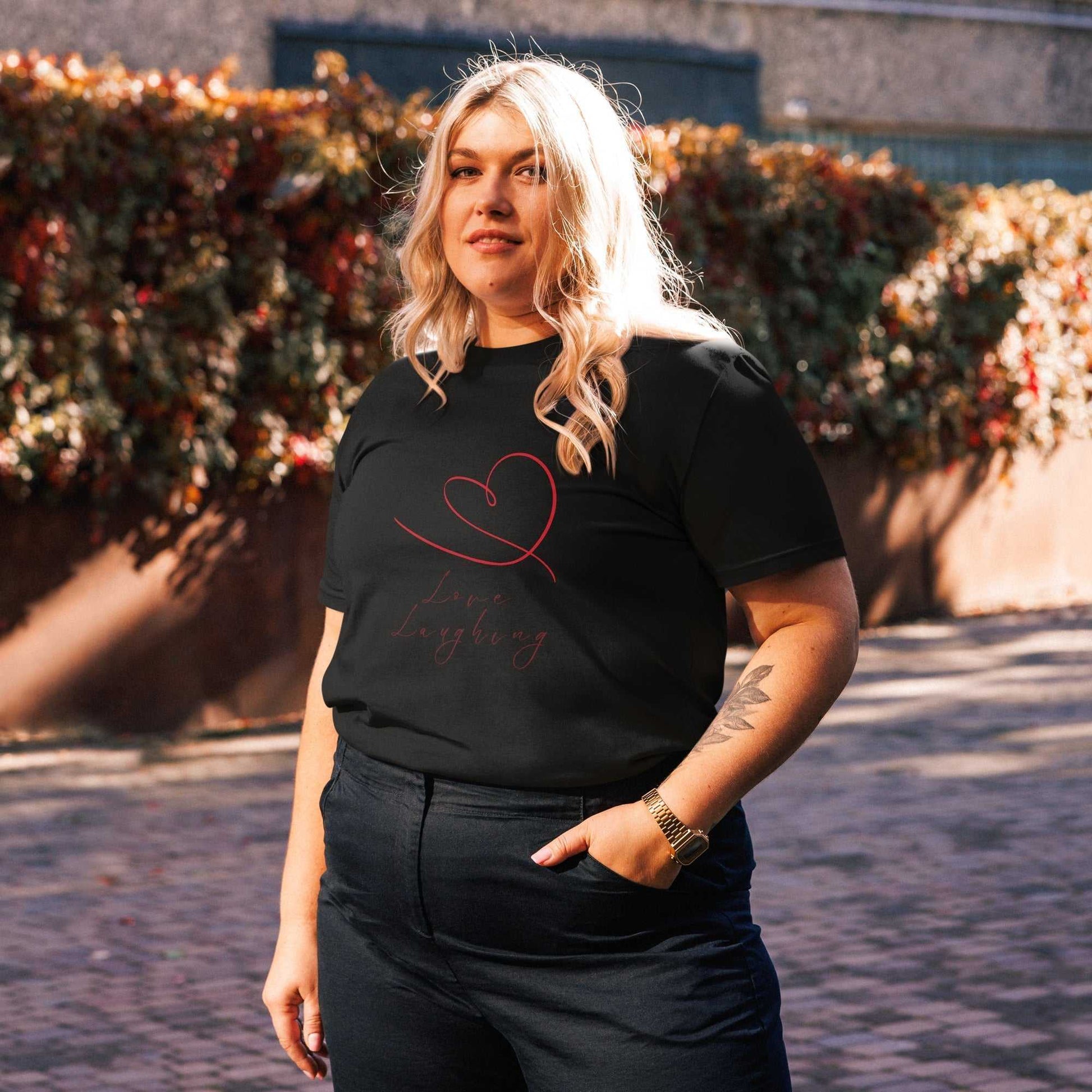 Black Love Laughing T-Shirt made from organic cotton, unisex fit with red heart and script design for everyday eco wear.