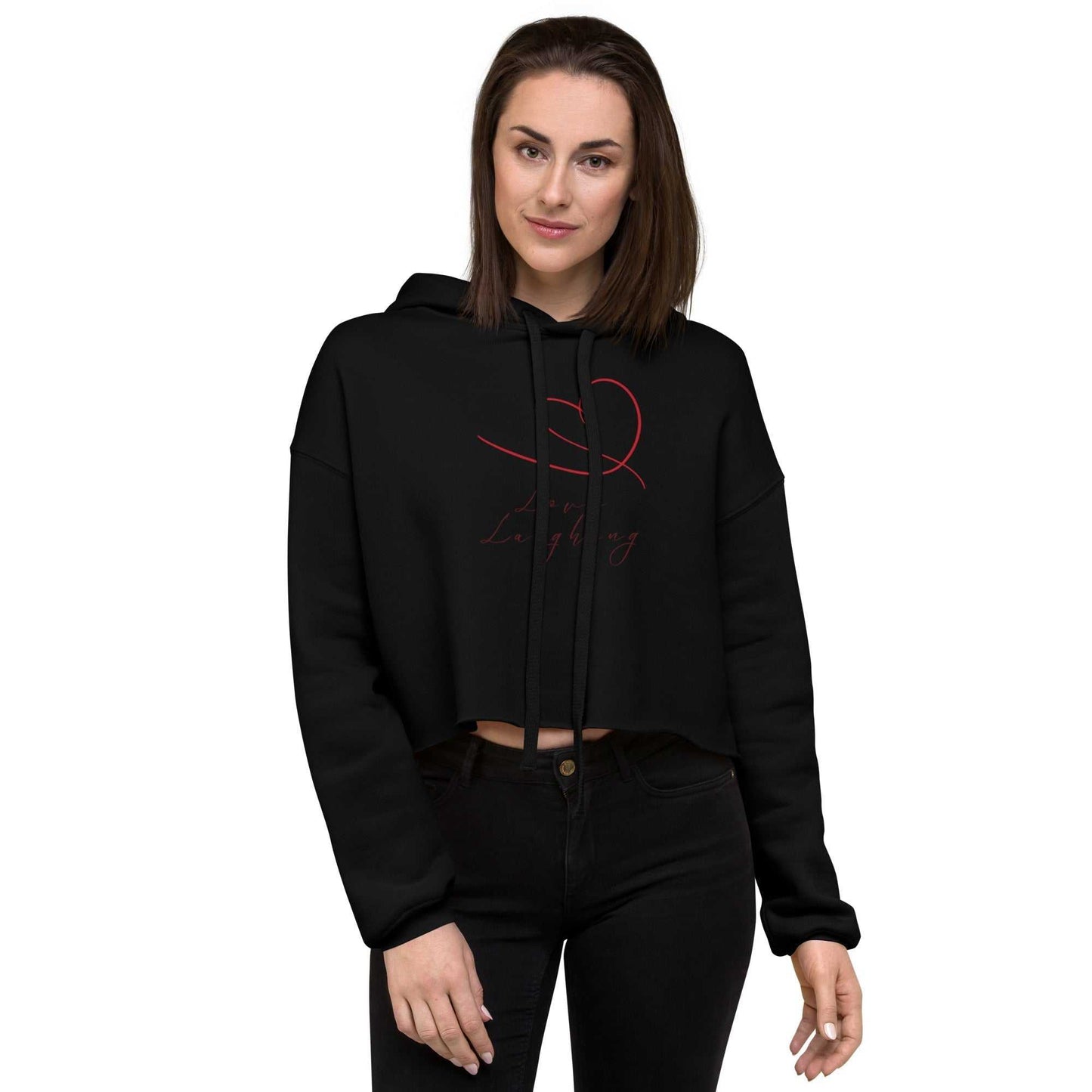 Model wearing black Love Laughing Women's Cropped Hoodie with red heart design, eco-friendly Valentine's activewear top.