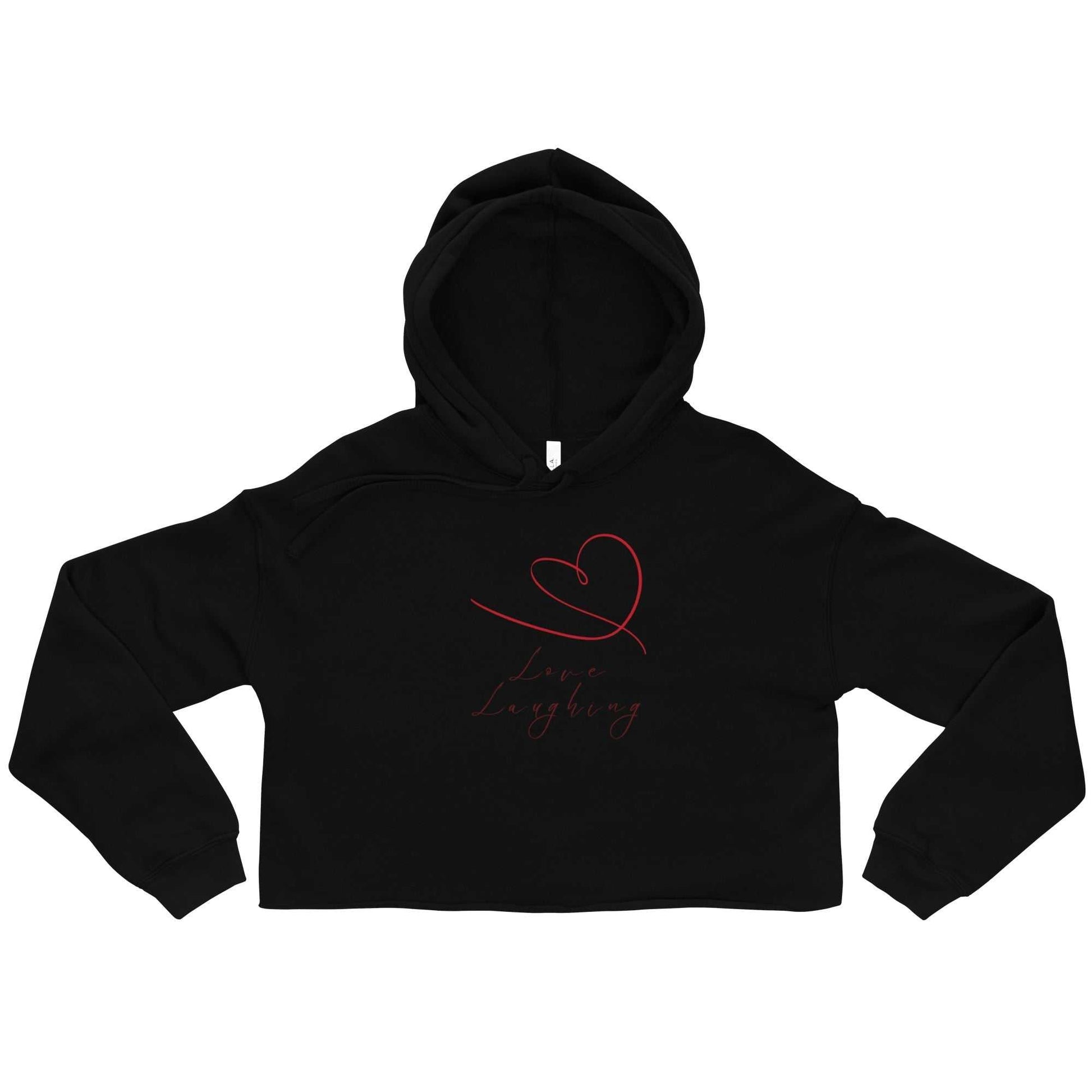 Flat lay of black Love Laughing Women's Cropped Hoodie with red heart and script. Valentine's eco-friendly fashion top for women.