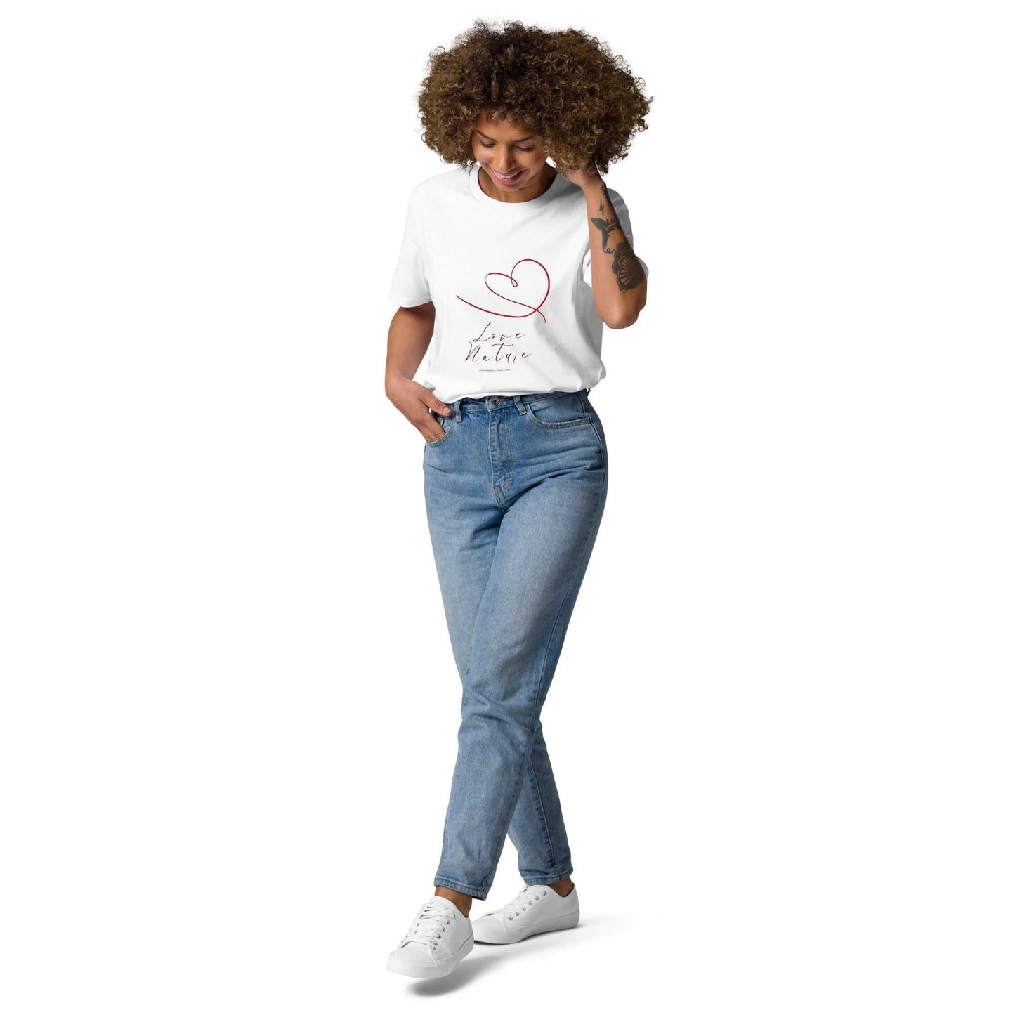 Front view of Love Nature Unisex Organic Cotton T-Shirt in white with red heart design, worn with jeans for a casual eco-conscious look.