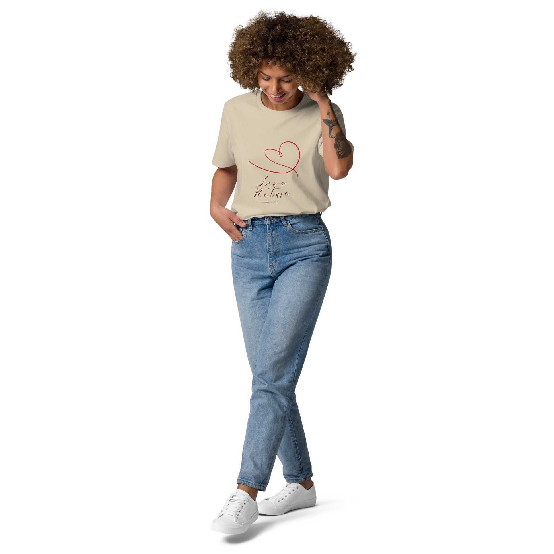Beige Love Nature unisex organic cotton t-shirt with red heart design, styled with jeans for a soft, sustainable fashion statement.