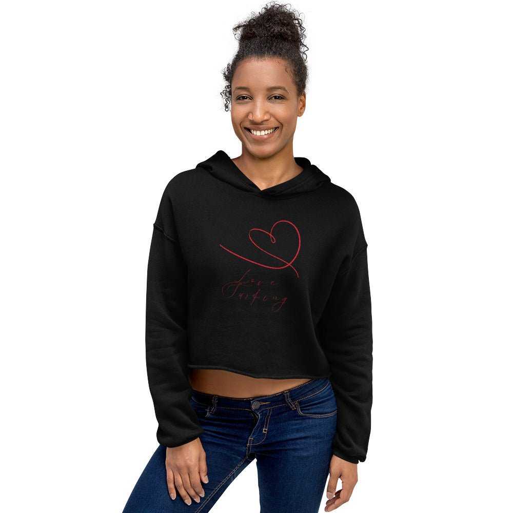 Model wearing black Love Surfing Women's Cropped Hoodie with red heart design, eco-friendly and stylish for casual outfits.