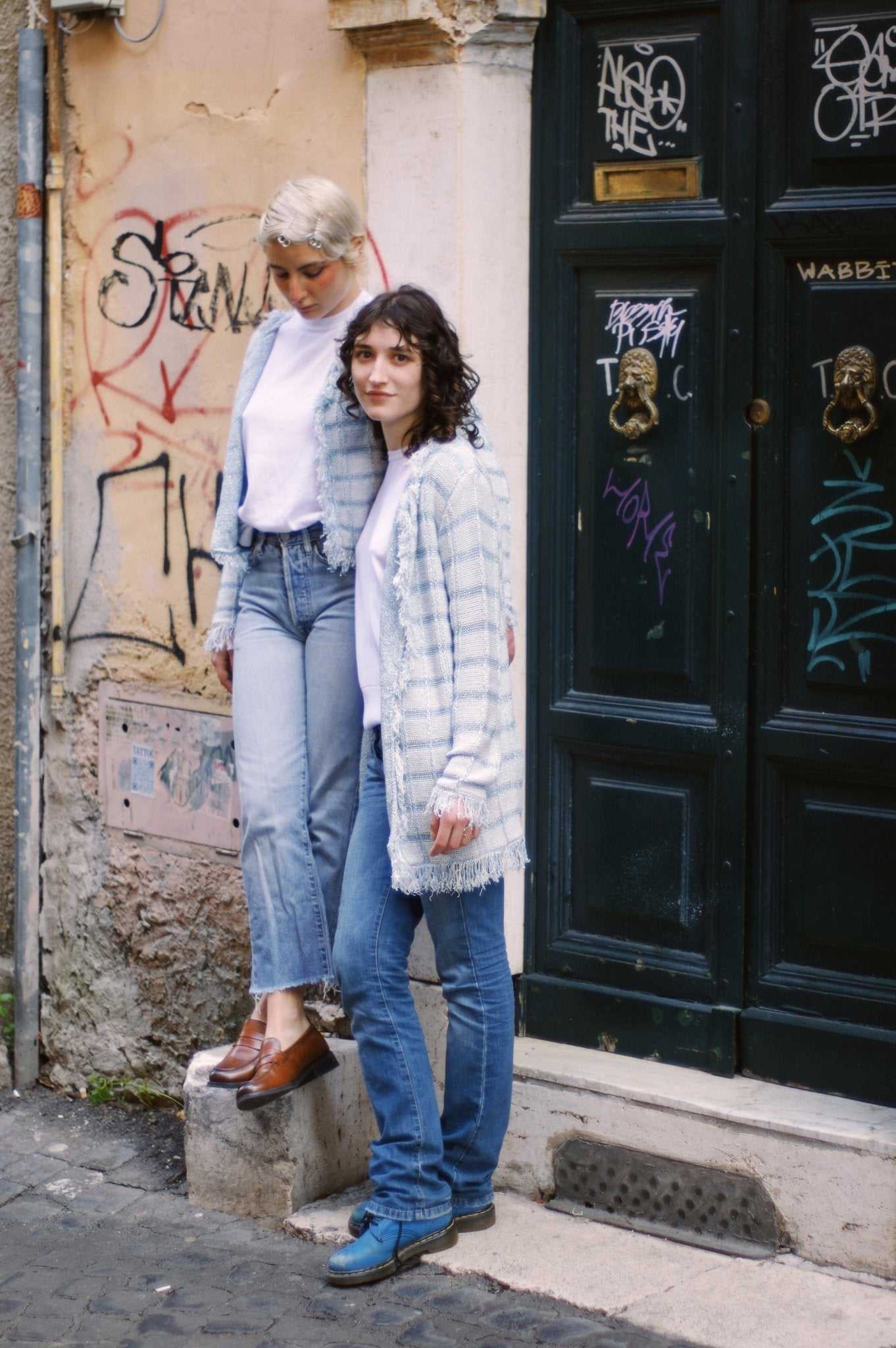 Two women wearing Olivia Midi Cardigans by Tenné in different colors, styled casually on a city street, showcasing Spring/Summer Italian knitwear.