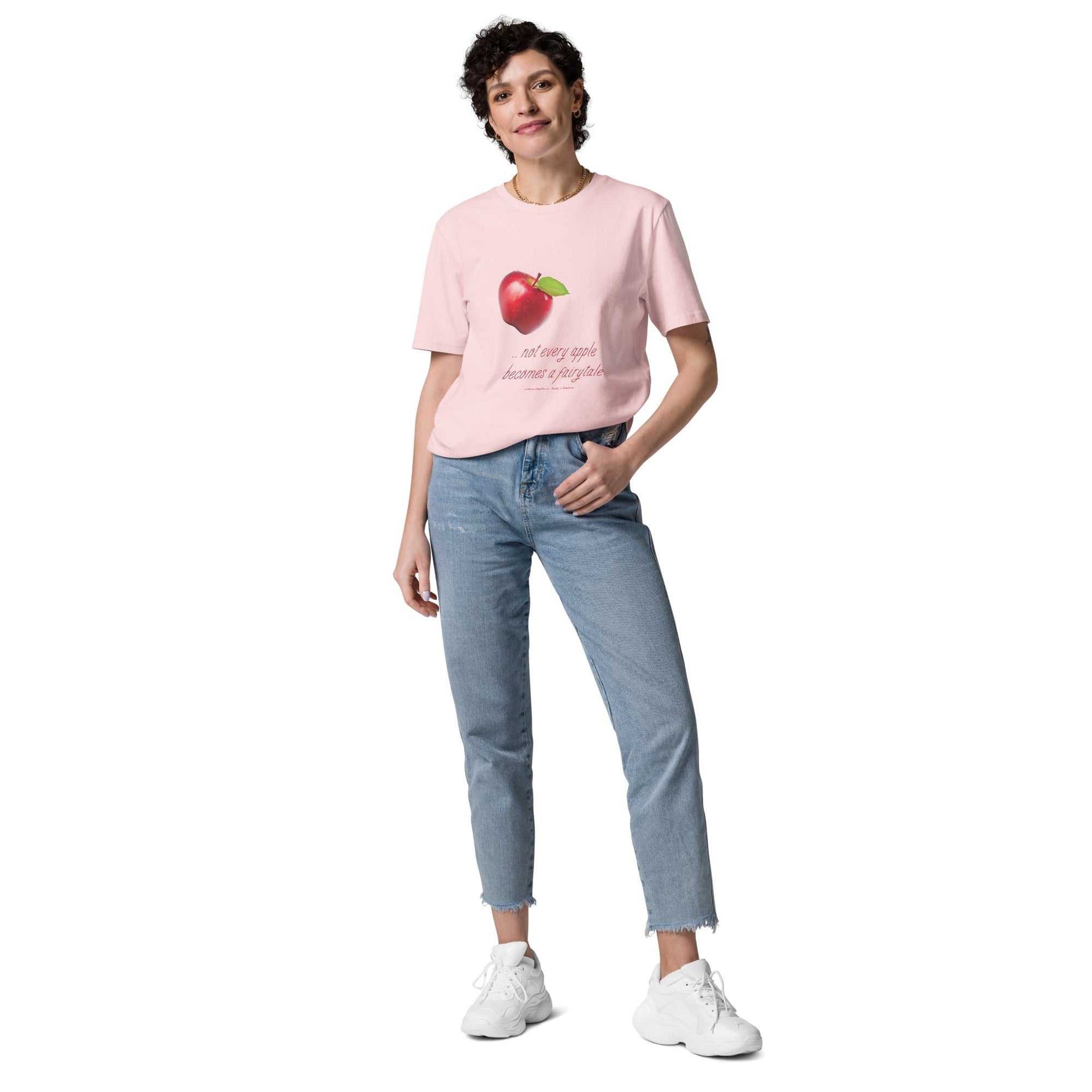 Light pink unisex organic cotton t-shirt with red apple graphic and 'Not every apple becomes a fairytale' text. Eco-friendly and witty fashion.