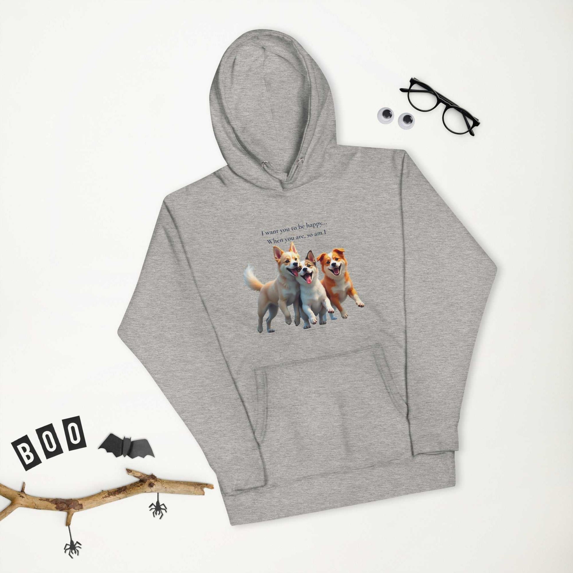 Flat lay of gray premium unisex hoodie with dog trio graphic and Halloween-themed props, ideal for cozy seasonal fashion.