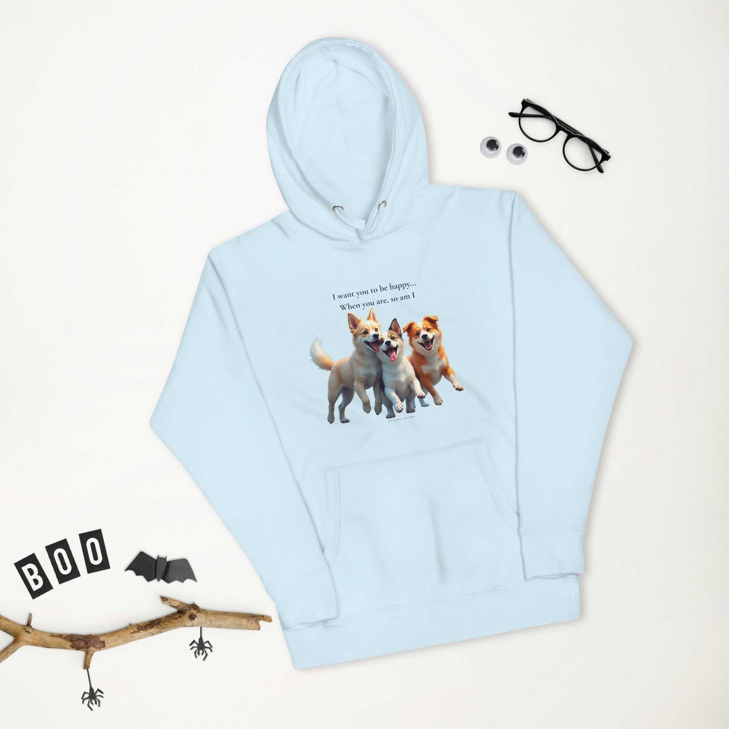 Flat lay of light blue premium unisex hoodie with dog print and Halloween props, ideal for cozy and cheerful seasonal wear.