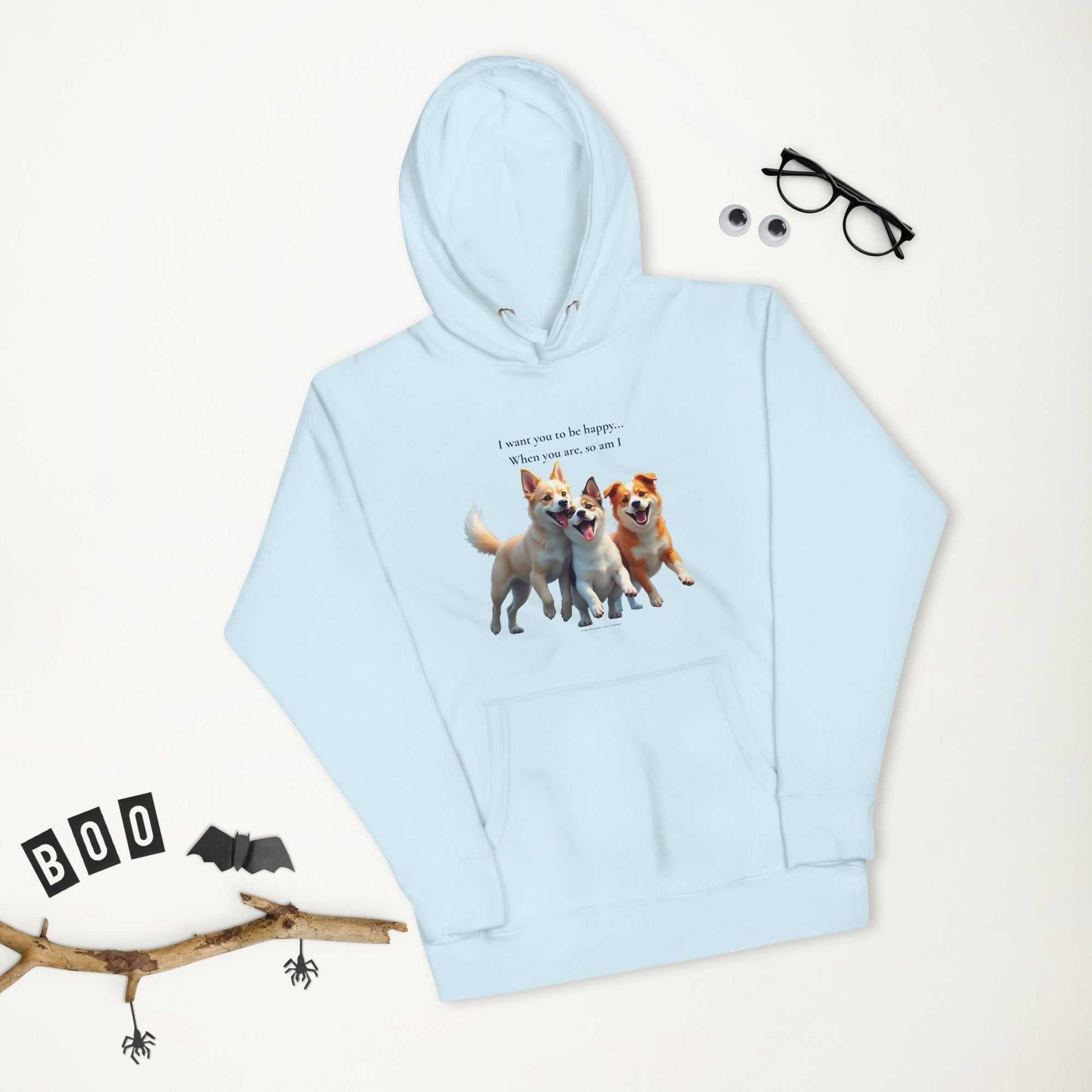Flat lay of light blue premium unisex hoodie with dog print and Halloween props, ideal for cozy and cheerful seasonal wear.