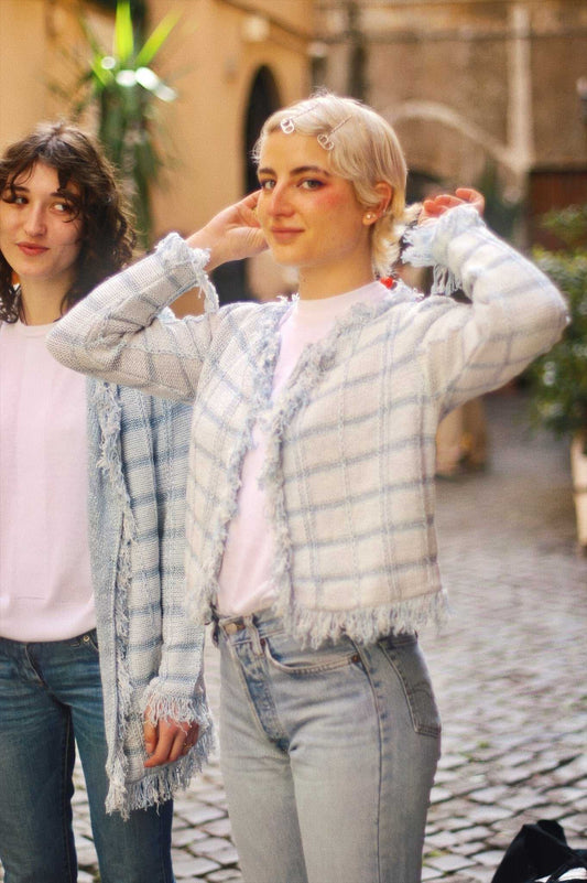 Ornella Short Cardigan with Lurex Inserts in blue plaid, styled with jeans for a casual spring look. Features fringe trim and soft texture.